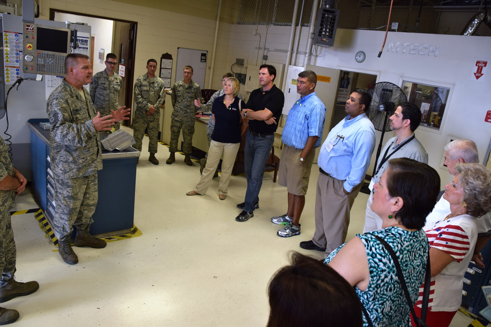 Tech. Sgt. David Miller (left), an aircraft metals technician with the 433rd Maintenance Squadron, explains his shops capabilities to the to the 433rd Airlift Wing honorary commanders on Aug. 15, 2015 at Joint Base San Antonio-Lackland, Texas. The honorary commanders toured the maintenance operations center, a C-5A Galaxy , engine shop and maintenance shops (U.S. Air Force photo by Tech. Sgt. Carlos J. Trevino)