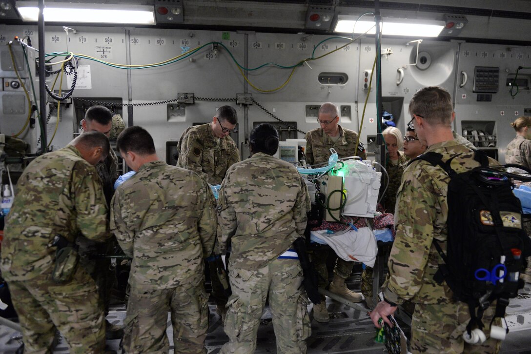 U.S. Airmen assigned to the 455th Expeditionary Aeromedical Evacuation Squadron and 455th Expeditionary Medical Group load an injured Service member onto a C-17 Globemaster III aircraft on the flight line at Bagram Airfield, Afghanistan, Aug. 8, 2015.  The 455th EAES Airmen are charged with the responsibility of evacuating the sick and wounded from Central Command to higher echelons of medical care. (U.S. Air Force photo by Maj. Tony Wickman/Released) 