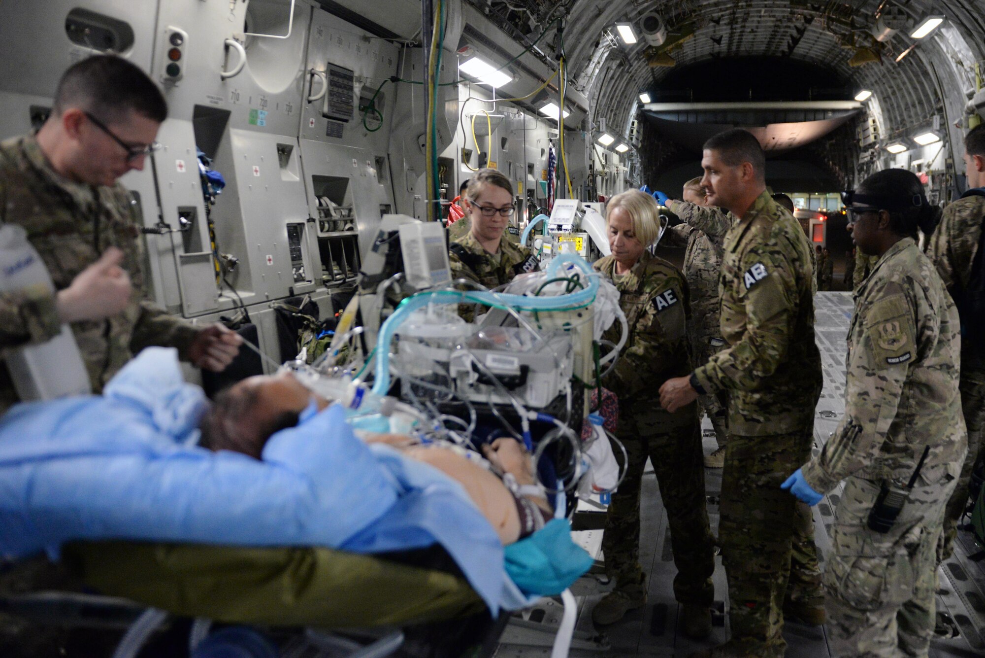 U.S. Airmen assigned to the 455th Expeditionary Aeromedical Evacuation Squadron check equipment and prepare an injured Service member for transport on a C-17 Globemaster III aircraft from Bagram Airfield, Afghanistan, to Ramstein Air Base, Germany, Aug. 8, 2015. The 455th EAES Airmen are charged with the responsibility of evacuating the sick and wounded from Central Command to higher echelons of medical care. (U.S. Air Force photo by Maj. Tony Wickman/Released) 