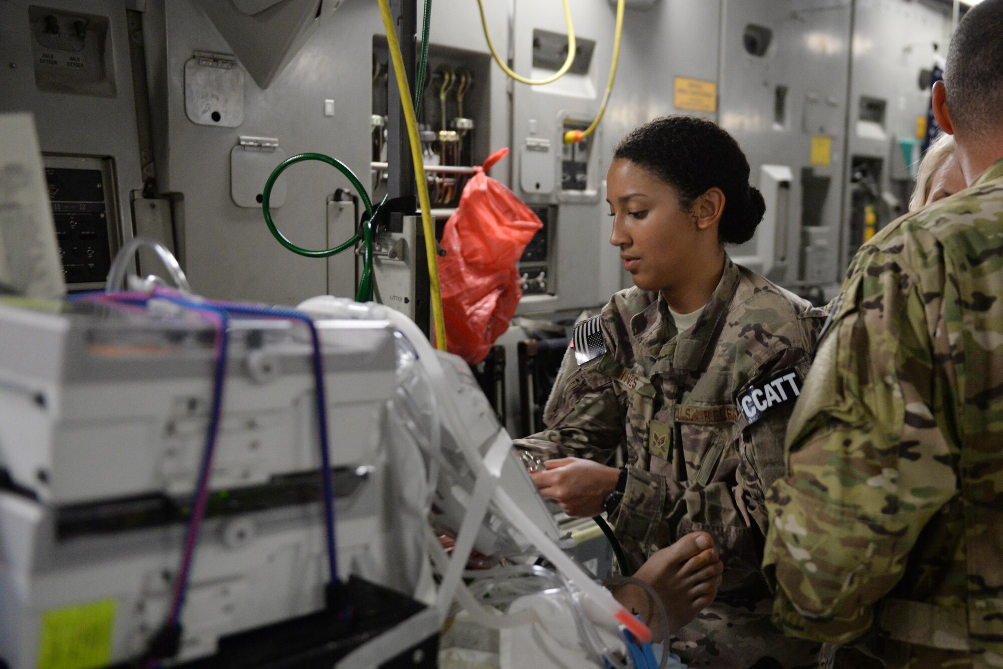 U.S. Air Force Senior Airman Natalie Hives, 455th Expeditionary Aeromedical Evacuation Squadron’s Critical Care Air Transport Team respiratory therapist, checks on an injured Service member during an aeromedical evacuation mission on a C-17 Globemaster III aircraft from Bagram Airfield, Afghanistan, Aug. 8, 2015.  The 455th EAES Airmen are charged with the responsibility of evacuating the sick and wounded from Central Command to higher echelons of medical care. (U.S. Air Force photo by Maj. Tony Wickman/Released) 