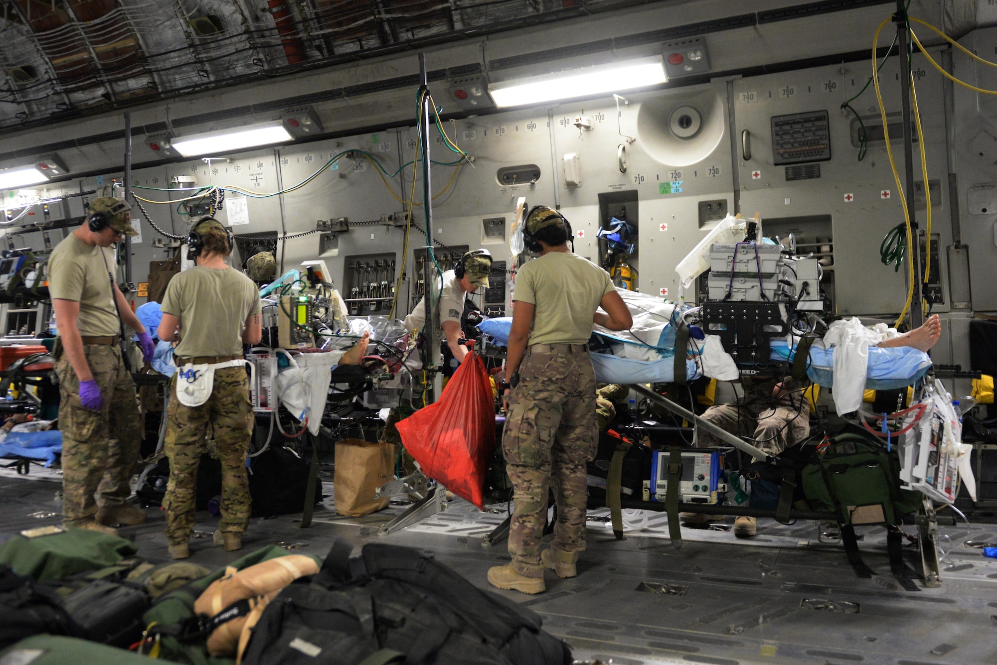 U.S. Airmen assigned to the 455th Expeditionary Aeromedical Evacuation Squadron provide in flight medical care to injured Service members on a C-17 Globemaster III aircraft that departed Bagram Airfield, Afghanistan, heading for medical care in Germany, Aug. 9, 2015.  The 455th EAES Airmen are charged with the responsibility of evacuating the sick and wounded from Central Command to higher echelons of medical care. (U.S. Air Force photo by Maj. Tony Wickman/Released) 