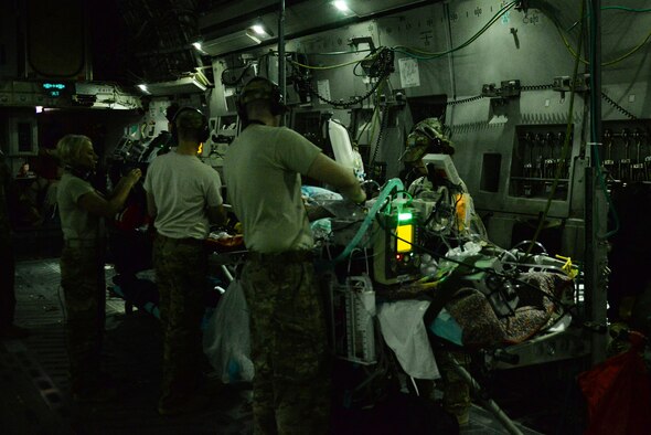 Airmen assigned to the 455th Expeditionary Aeromedical Evacuation Squadron provide in-flight medical care to injured service members on a C-17 Globemaster III that departed Bagram Airfield, Afghanistan, heading for medical care in Germany Aug. 9, 2015. The 455th EAES Airmen are charged with the responsibility of evacuating the sick and wounded from U.S. Central Command to higher echelons of medical care. (U.S. Air Force photo/Maj. Tony Wickman)