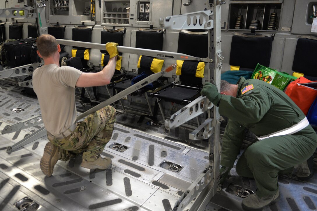 U.S. Airmen assigned to the 455th Expeditionary Aeromedical Evacuation Squadron break down their equipment on a C-17 Globemaster III aircraft that transported injured Service members from Bagram Airfield, Afghanistan, to Ramstein Air Base, Germany, Aug. 9, 2015.  The 455th EAES Airmen are charged with the responsibility of evacuating the sick and wounded from Central Command to higher echelons of medical care. (U.S. Air Force photo by Maj. Tony Wickman/Released) 