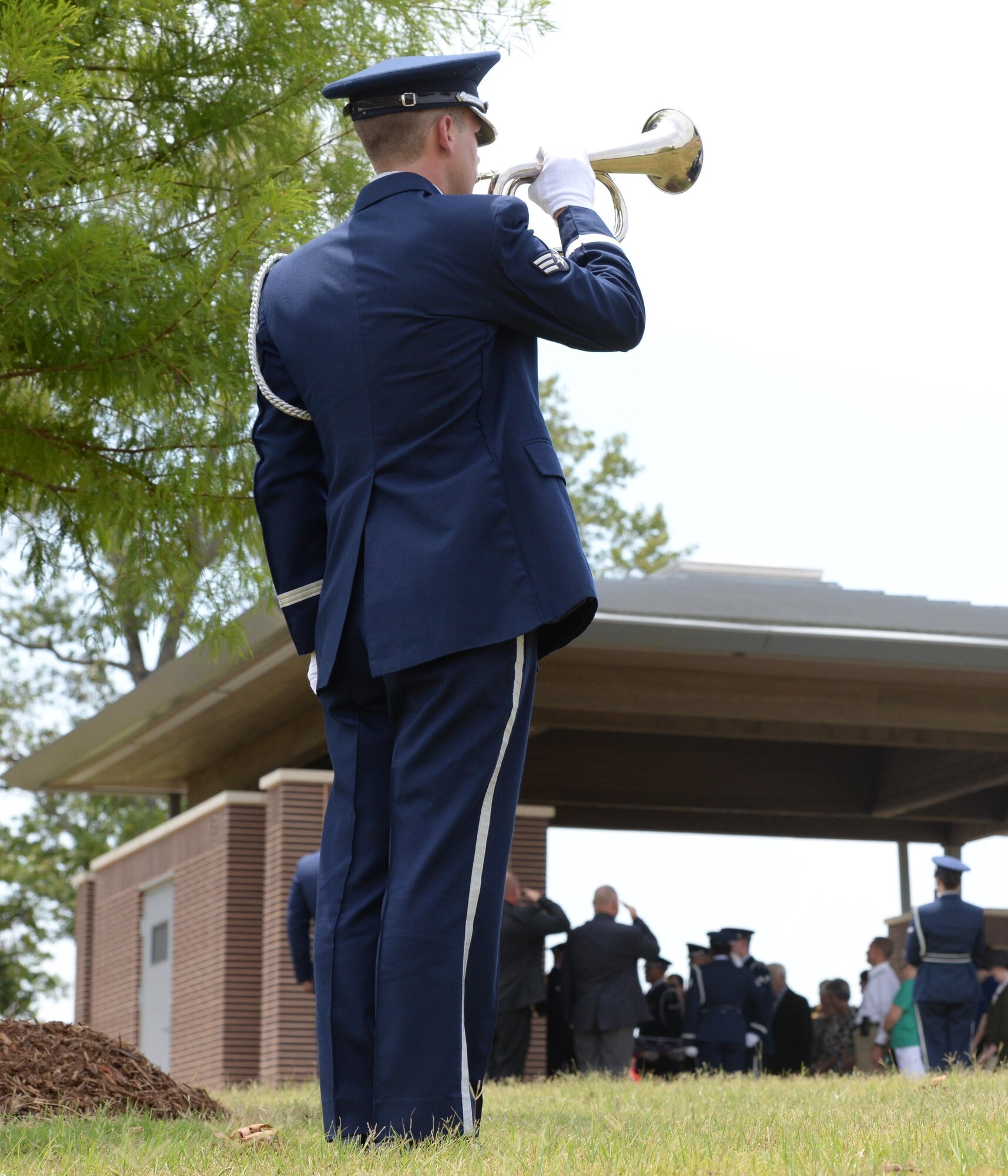 Senior Airman Justin Keller, Columbus Air Force Base Honor guardsman, plays Taps for a Missing in Action ceremony for Capt. Frederick Partridge Aug. 10 at the Mississippi Veterans Memorial Cemetery. A native of Sumner, Mississippi, Partridge served in both World War II and in Korea in his eight years of service until he was shot down the morning of Aug. 10, 1952. (U.S. Air Force photo by 2nd Lt. Lauren Woods)