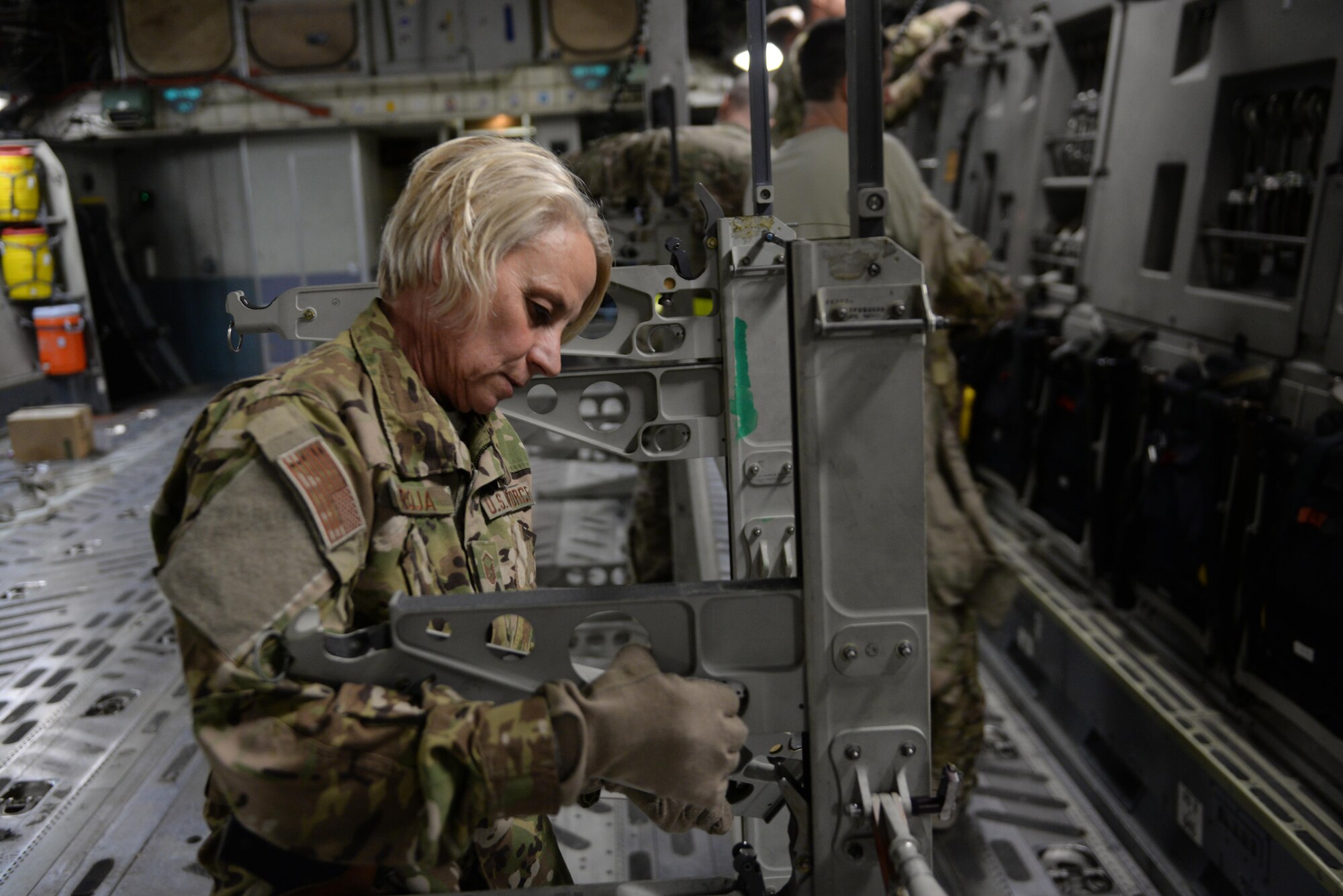 U.S. Air Force Master Sgt. Mary Troja, 455th EAES AE technician deployed from the Air Force Reserve’s 315th Aeromedical Evacuation Squadron  at Joint Base Charleston, South Carolina, erects a litter stanchion aboard a C-17 Globemaster III on the flight line at Bagram Airfield, Afghanistan, Aug. 8, 2015, to support an aeromedical evacuation mission.  The 455th EAES Airmen are charged with the responsibility of evacuating the sick and wounded from Central Command to higher echelons of medical care. (U.S. Air Force photo by Maj. Tony Wickman/Released) 