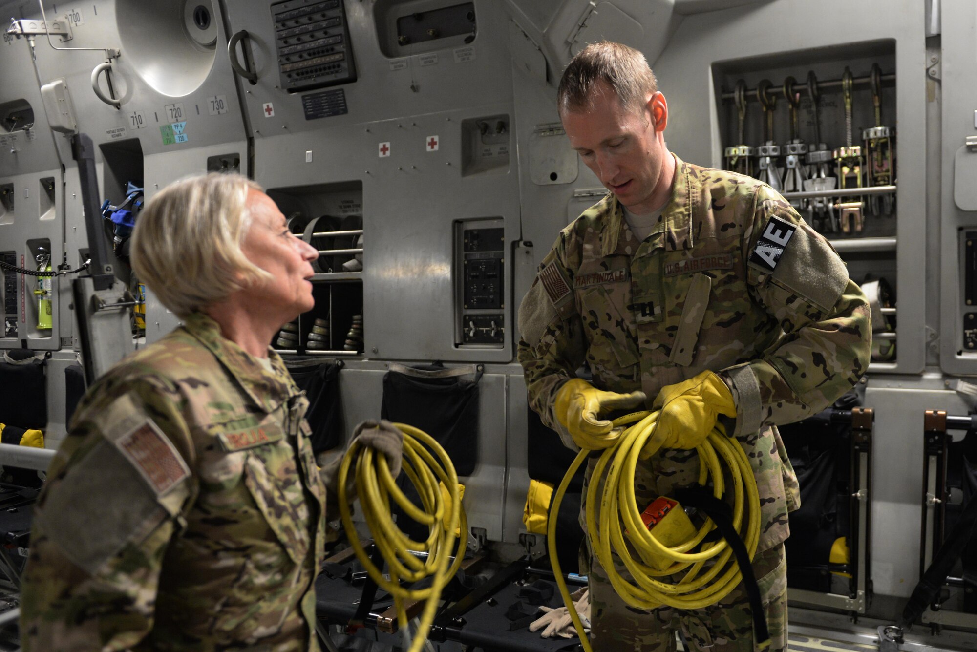 U.S. Air Force Master Sgt. Mary Troja, left, 455th EAES AE technician deployed from the Air Force Reserve’s 315th Aeromedical Evacuation Squadron at Joint Base Charleston, South Carolina, and and Capt. Derek Martindale, 455th EAES flight nurse deployed from the 315th AES, break down their equipment on a C-17 Globemaster III aircraft that transported injured Service members from Bagram Airfield, Afghanistan, to Ramstein Air Base, Germany, Aug. 8, 2015.  The 455th EAES Airmen are charged with the responsibility of evacuating the sick and wounded from Central Command to higher echelons of medical care. (U.S. Air Force photo by Maj. Tony Wickman/Released) 