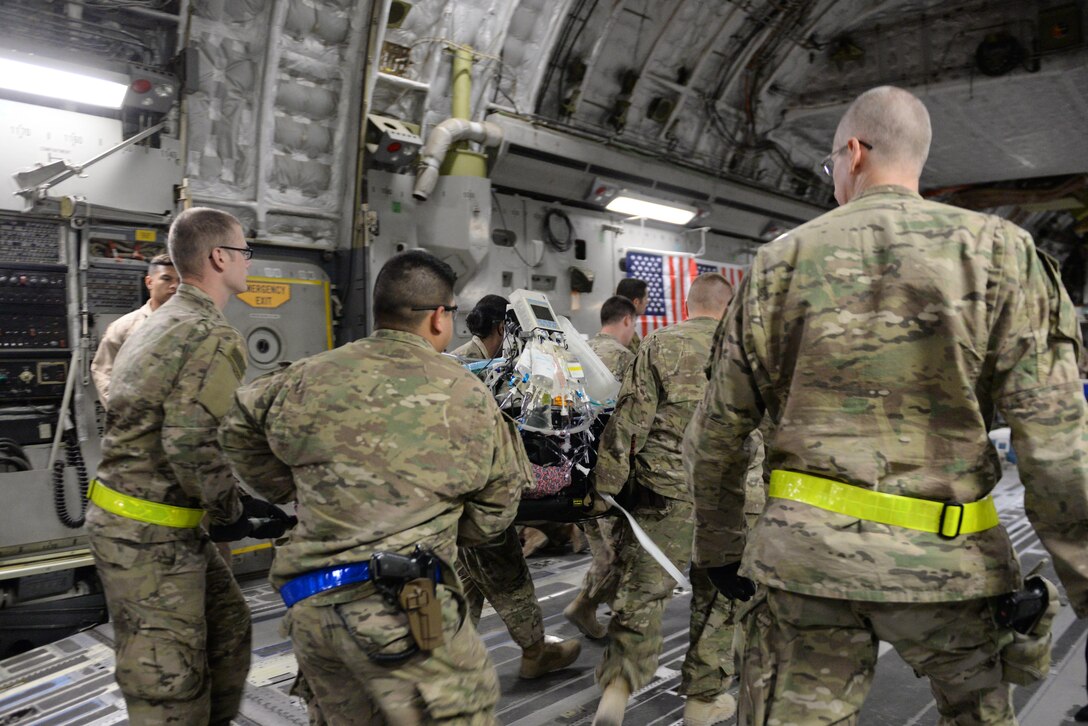 U.S. Airmen assigned to the 455th Expeditionary Aeromedical Evacuation Squadron and the 455th Expeditionary Medical Group load an injured Service member onto a C-17 Globemaster III aircraft on the flight line at Bagram Airfield, Afghanistan, Aug. 8, 2015.  The 455th EAES Airmen are charged with the responsibility of evacuating the sick and wounded from Central Command to higher echelons of medical care. (U.S. Air Force photo by Maj. Tony Wickman/Released) 