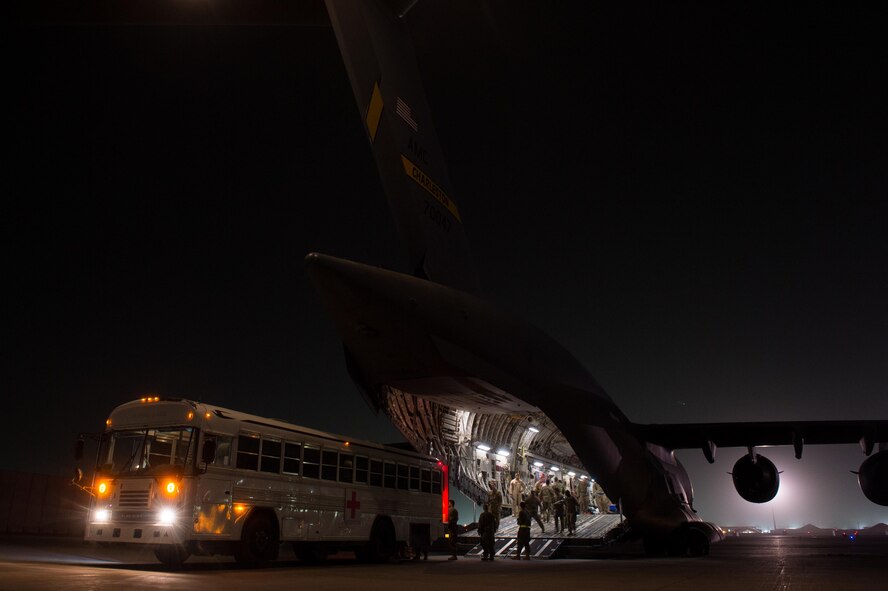 Airmen assigned to the 455th Expeditionary Aeromedical Evacuation Squadron and the 455th Expeditionary Medical Group load injured service members onto a C-17 Globemaster III on the flightline at Bagram Airfield, Afghanistan, Aug. 8, 2015. The 455th EAES Airmen are charged with the responsibility of evacuating the sick and wounded from U.S. Central Command to higher echelons of medical care. (U.S. Air Force photo/Tech. Sgt. Joseph Swafford)