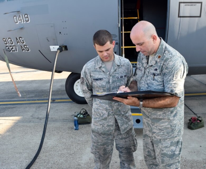 Maj. Paul Centinaro, 913th Maintenance Squadron commander, signs the Exceptional Release forms as Tech. Sgt. Timothy Hammonds, the 913th MXS dedicated crew chief, looks on July 28, 2015, Little Rock Air Force Base, Ark.The ER from is how maintenance transfers ownership of the airplane to operations. During the ER process, maintenance verifies all maintenance and inspections are complete and the airplane is in flyable condition.