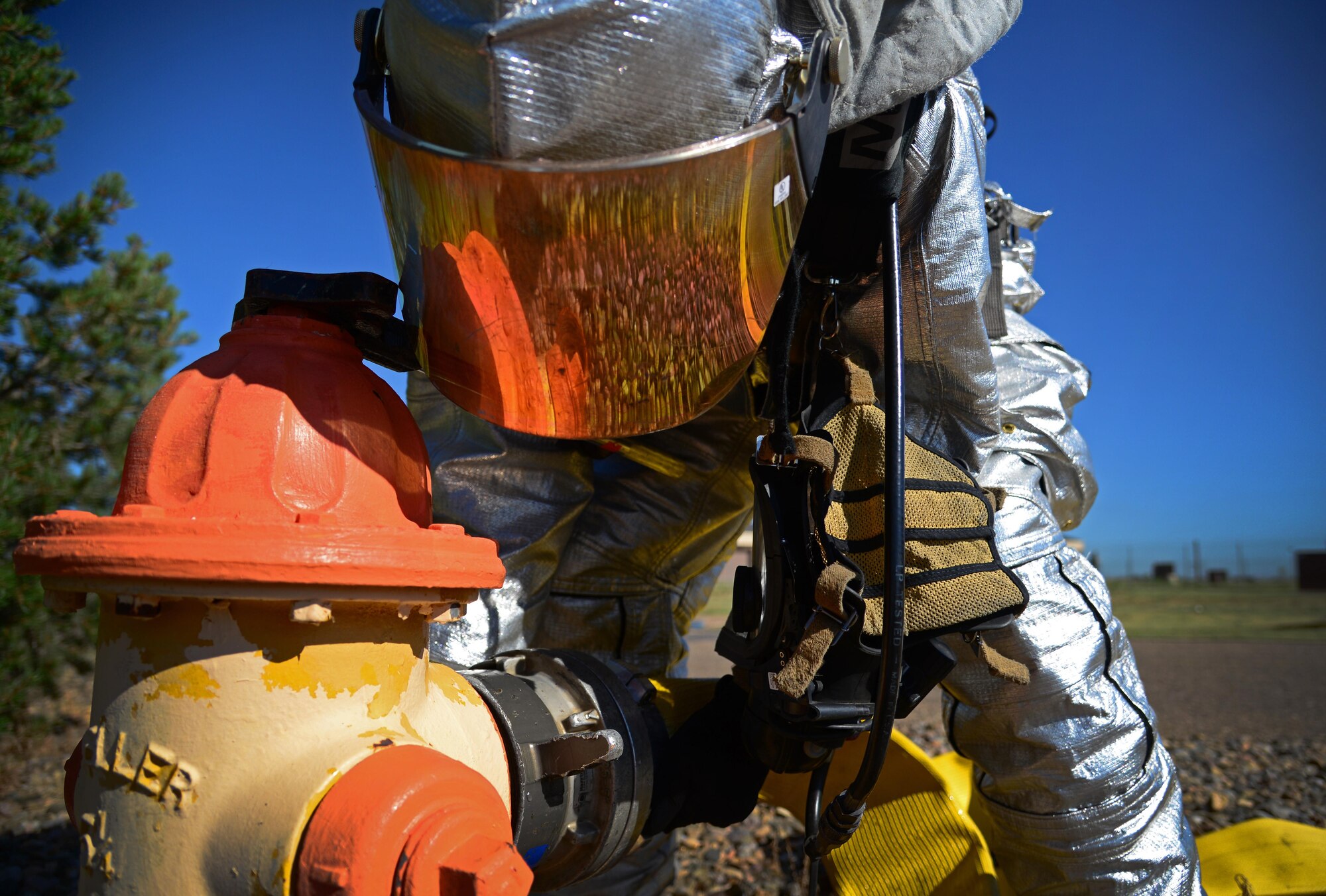 A firefighter with the 27th Special Operations Civil Engineer Squadron secures a hose to a hydrant during an exercise Aug. 4, 2015 at Cannon Air Force Base, N.M. While Cannon firefighters were in no actual danger, evaluators were on site injecting additional benchmarks to add to the realism of the exercise scenario. (U.S. Air Force photo/Staff Sgt. Alexx Mercer)