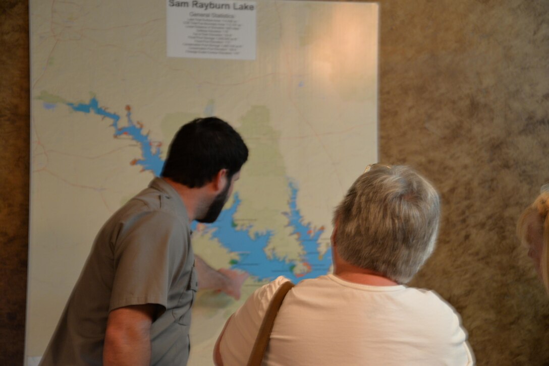A park ranger provides details to a local resident concerning the Sam Rayburn Reservoir Shoreline Management Plan during a recent public meeting.