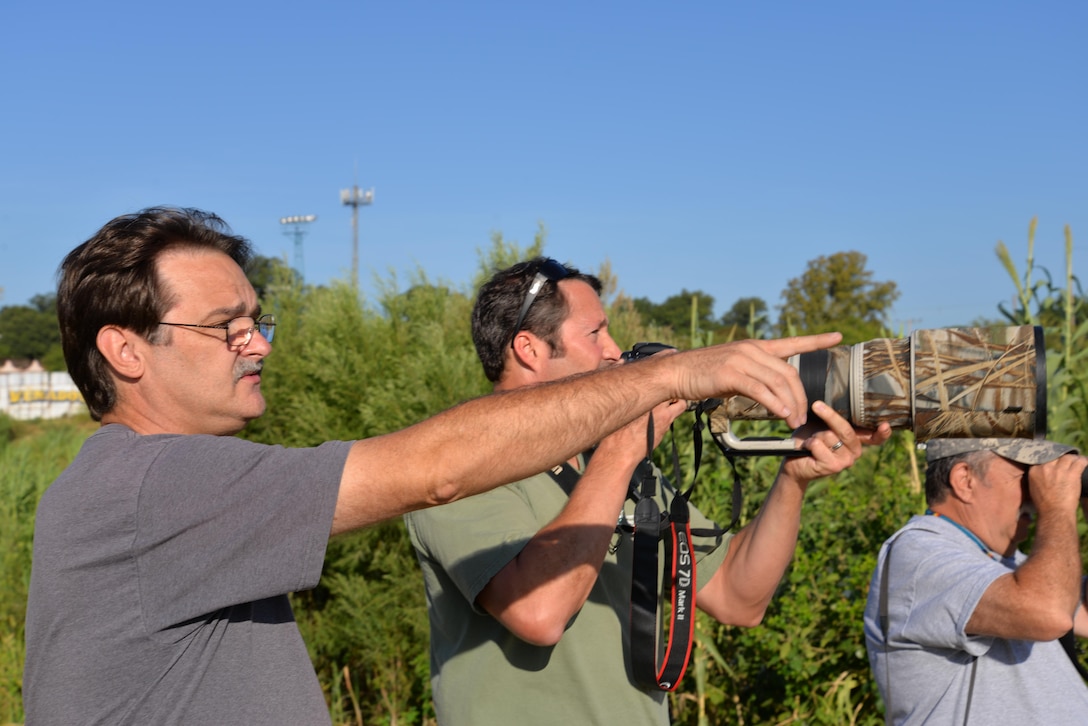 Corps employees look at local bird species during a site visit to Eagle Pass, Texas, near the Rio Grande River.  