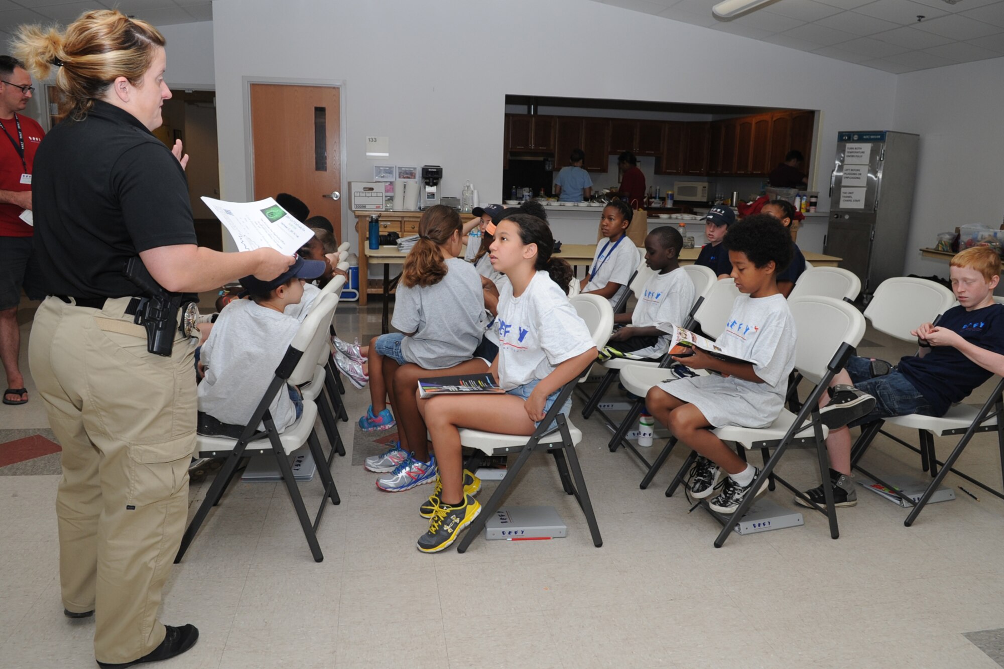 Erica A. Morris, San Angelo Police Department Drug Resistance Education and Mentoring officer, talks to Drug Education for Youth participant at the Taylor Chapel, Goodfellow Air Force Base, Texas, Aug. 6, 2015. DREAM was developed by the San Angelo Police Department in 2008, to address local needs and concerns affecting the youth in the community. (U.S. Air Force photo by Staff Sgt. Laura R. McFarlane/Released)