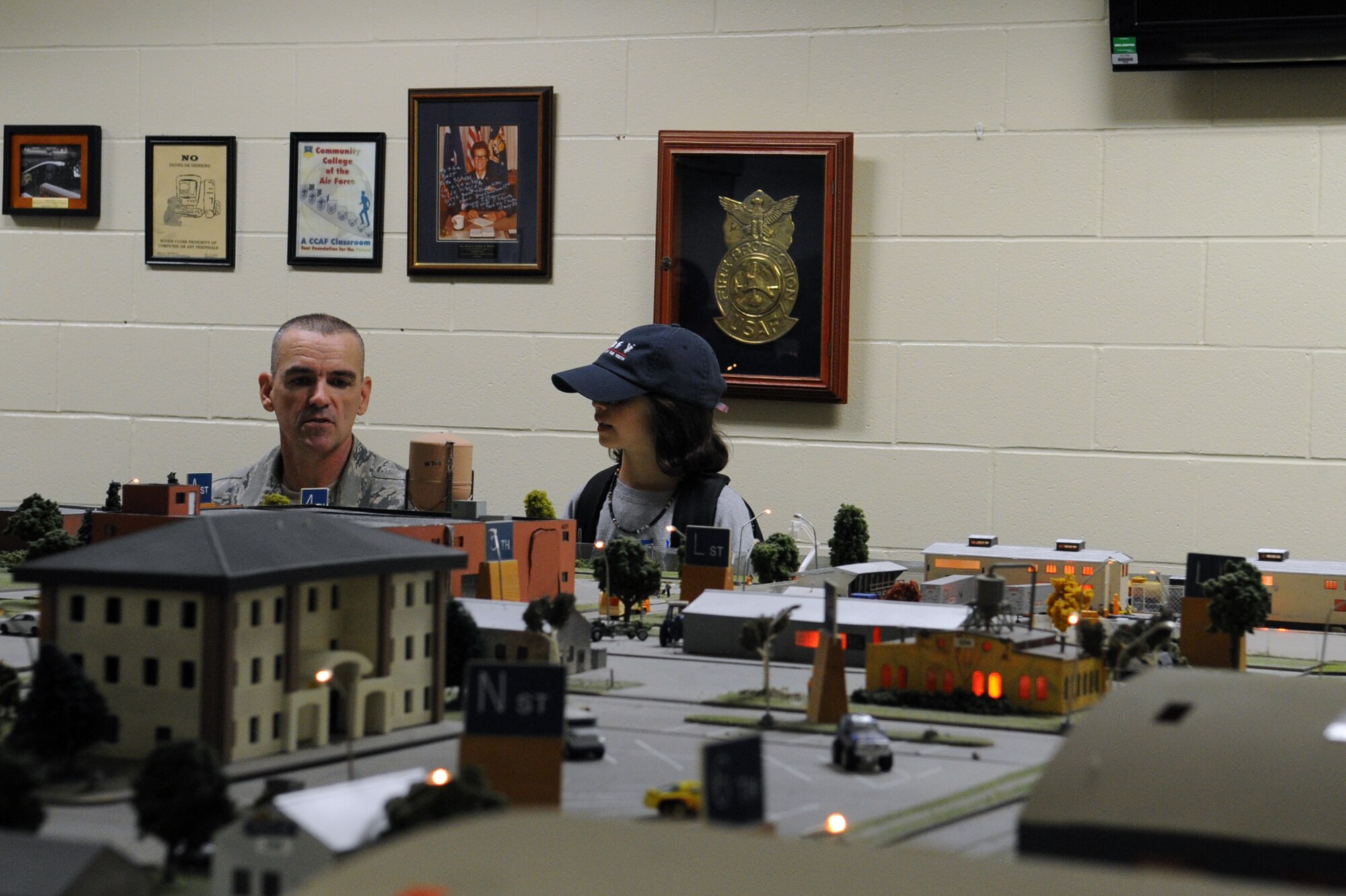 U.S. Air Force Master Sgt. Dwayne K. Jackson, 312th Training Squadron block 4 instructor supervisor, briefs a Drug Education for Youth participant on the Norma Brown Air Force Base trainer at the Louis F. Garland Department of Defense Fire Academy, Goodfellow Air Force Base, Texas, Aug. 6, 2015. The Norma Brown trainer gives students the opportunity to build experience as an on-scene commander. (U.S. Air Force photo by Staff Sgt. Laura R. McFarlane/Released) 