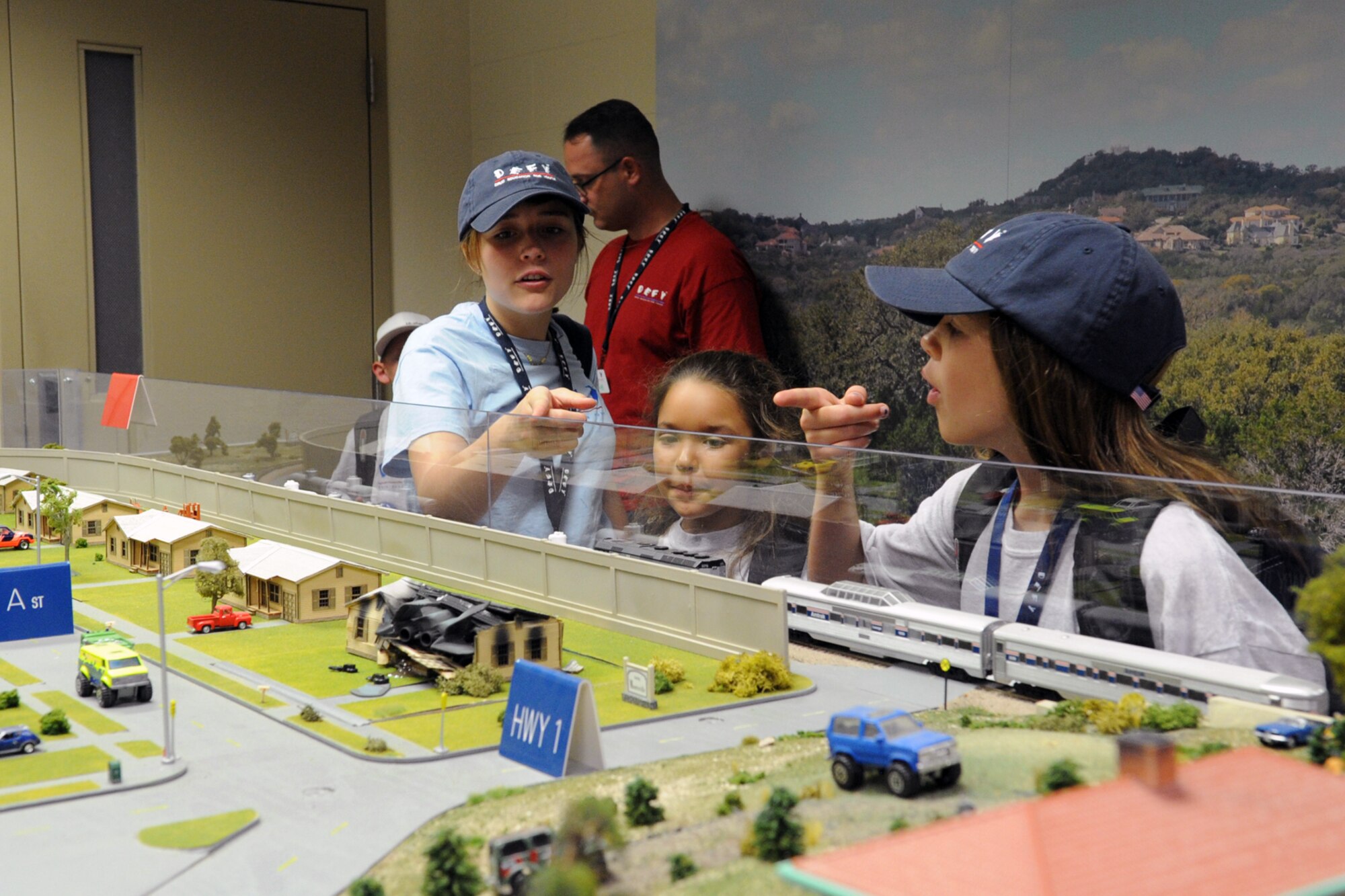 Drug Education for Youth participants point out a crashed jet on the Mooresville trainer at the Louis F. Garland Department of Defense Fire Academy, Goodfellow Air Force Base, Texas, Aug. 6, 2015. The Mooresville trainer is used for officer training courses two and three. (U.S. Air Force photo by Staff Sgt. Laura R. McFarlane/Released)