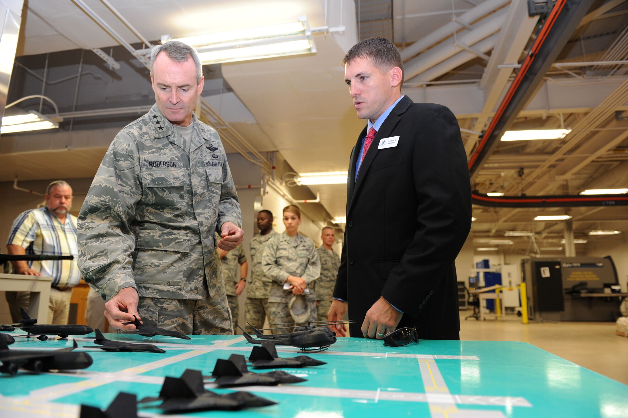 Tomme Lassabe, 81st Training Support Squadron training technology flight chief, explains to Lt. Gen. Darryl Roberson, commander of Air Education and Training Command, how 3-D printed model aircraft help bring realism into the classroom and base operations, Aug. 12, 2015, Keesler Air Force Base, Mississippi. Roberson was accompanied by his wife, Cheryl, and Chief Master Sgt. Gerardo Tapia, AETC command chief.  The two-day visit also included a base all call and tours of the 81st Medical Group, the Levitow Training Support Facility, and 2nd Air Force headquarters. (U.S. Air Force photo by Kemberly Groue)