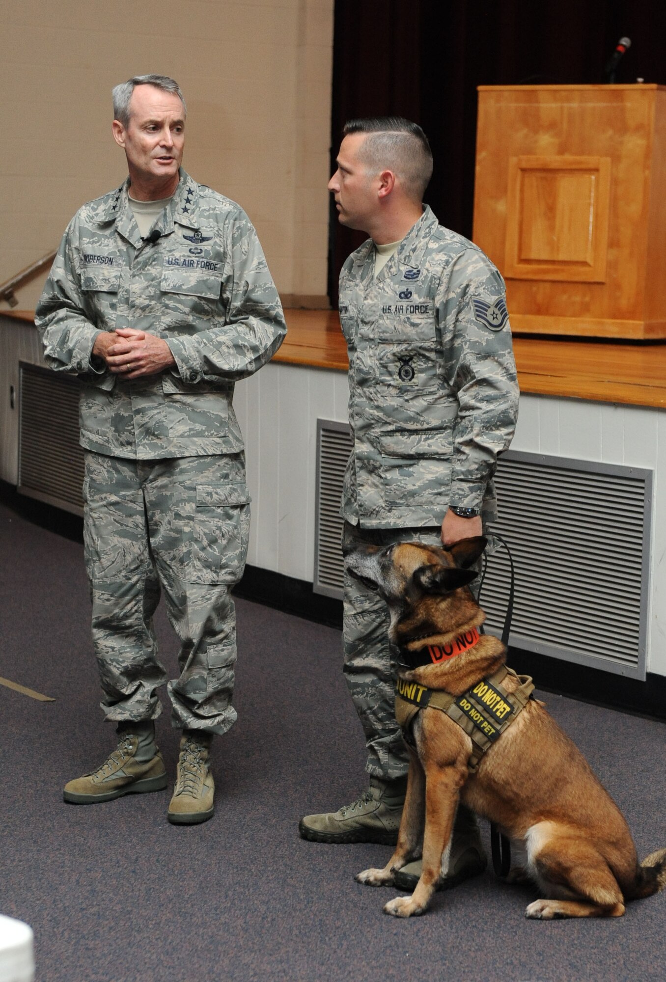 Lt. Gen. Darryl Roberson, commander of Air Education and Training Command, recognizes Staff Sgt. James Martin, 81st Security Forces Squadron kennel master, and his military working dog, Densy, for their actions while deployed during a base all call Aug. 12, 2015, at the Welch Theater, Keesler Air Force Base, Mississippi. During Roberson’s two-day site visit to Keesler he also toured the 81st Medical Group, Levitow Training Support Facility, Trainer Development Center and 2nd Air Force headquarters, while accompanied by his wife, Cheryl, and Chief Master Sgt. Gerardo Tapia, AETC command chief. (U.S. Air Force photo by Kemberly Groue)