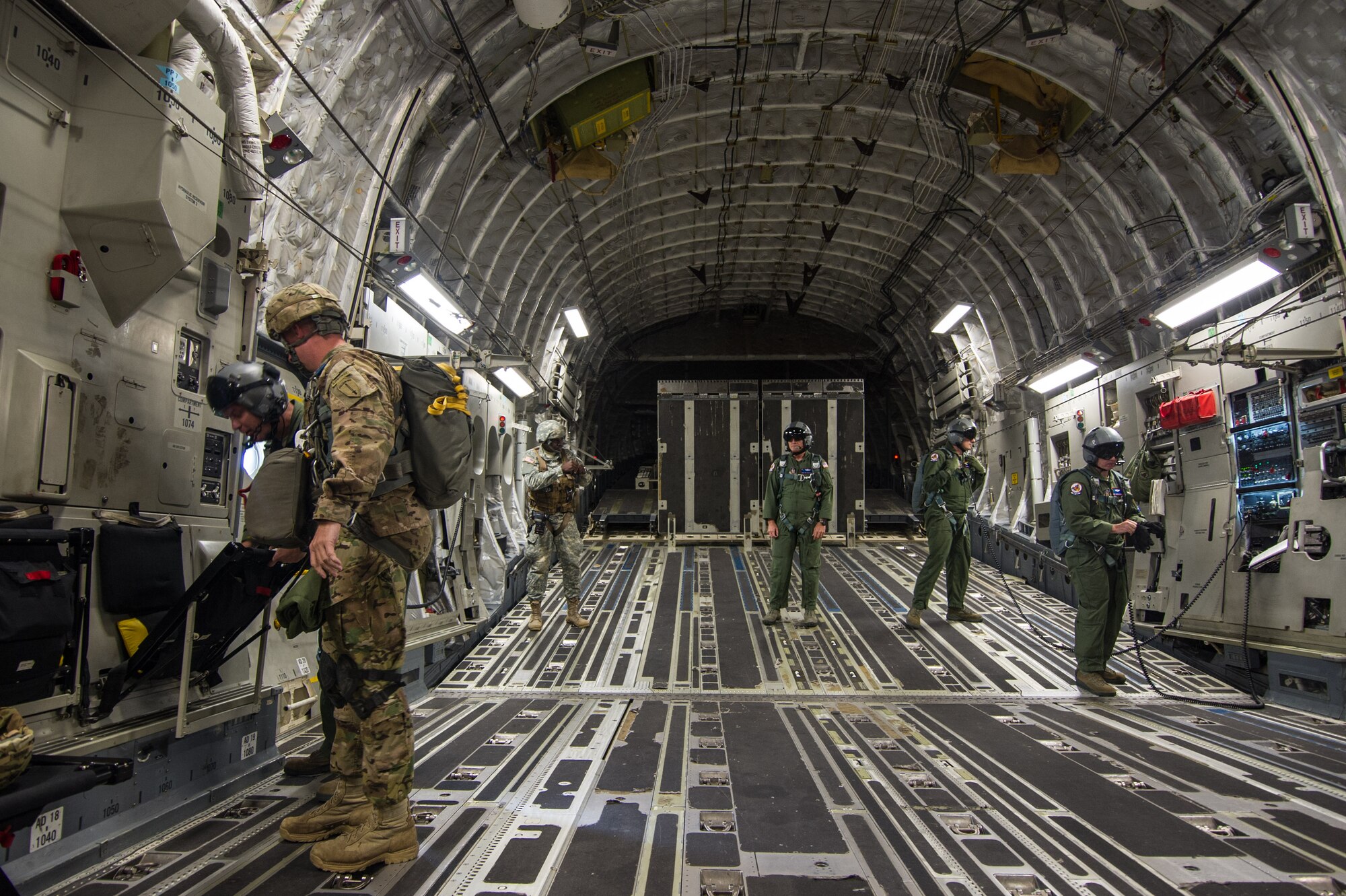 Loadmasters from the 701st Airlift Squadron at Joint Base Charleston, S.C. stand ready in a C-17 Globemaster III during a flight over Lawson Army Airfield, Fort Benning, Ga. Aug. 15, 2015. Reserve aircrews from the 701st and 300th AS flew two C-17s during Fort Benning’s celebration of the 75th anniversary of the U.S. Army Airborne School. Almost 300 paratroopers took the big leap in the day’s event. (U.S. Air Force photo by Staff Sgt. Bobby Pilch)