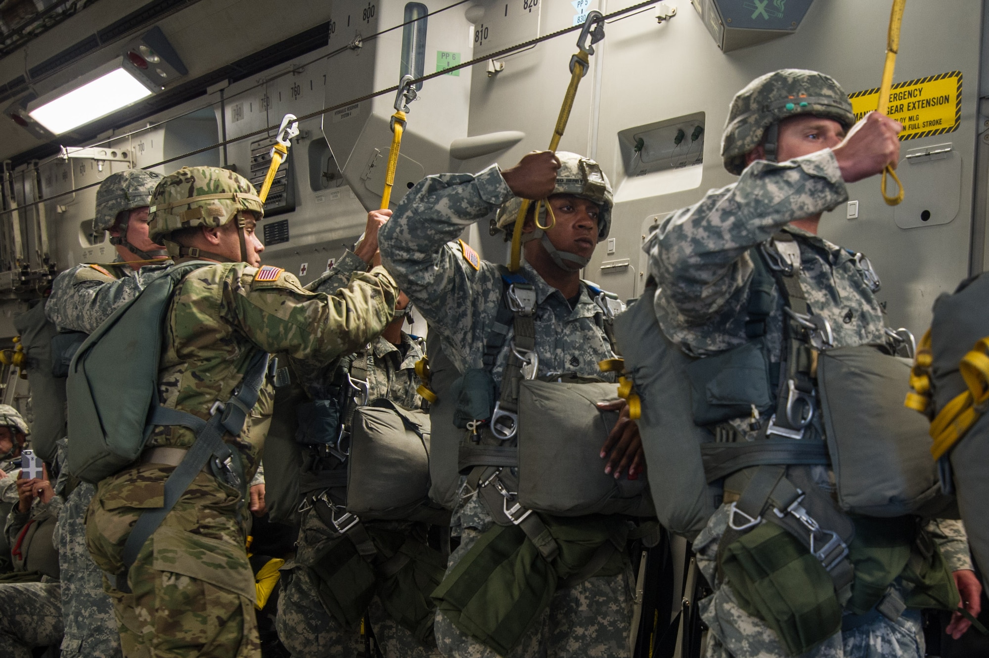 U.S. Army paratroopers prepare to jump out of a C-17 Globemaster III Aug. 15, 2015 during a flight over Lawson Army Airfield, Fort Benning, Ga. Reserve aircrews from the 701st and 300th Airlift Squadron out of Joint Base Charleston, S.C. flew two C-17s during Fort Benning’s celebration of the 75th anniversary of the U.S. Army Airborne School. Almost 300 paratroopers took the big leap in the day’s event. (U.S. Air Force photo by Staff Sgt. Bobby Pilch)