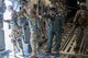 Master Sgt. Al Larson, 701st Airlift Squadron loadmaster and former U.S. Army paratrooper, communicates with hand signals during a flight over Lawson Army Airfield, Fort Benning, Ga. Aug. 15, 2015. Reserve aircrews from the 701st and 300th AS out of Joint Base Charleston, S.C. flew two C-17s during Fort Benning’s celebration of the 75th anniversary of the U.S. Army Airborne School. Almost 300 paratroopers took the big leap in the day’s event. (U.S. Air Force photo by Staff Sgt. Bobby Pilch)