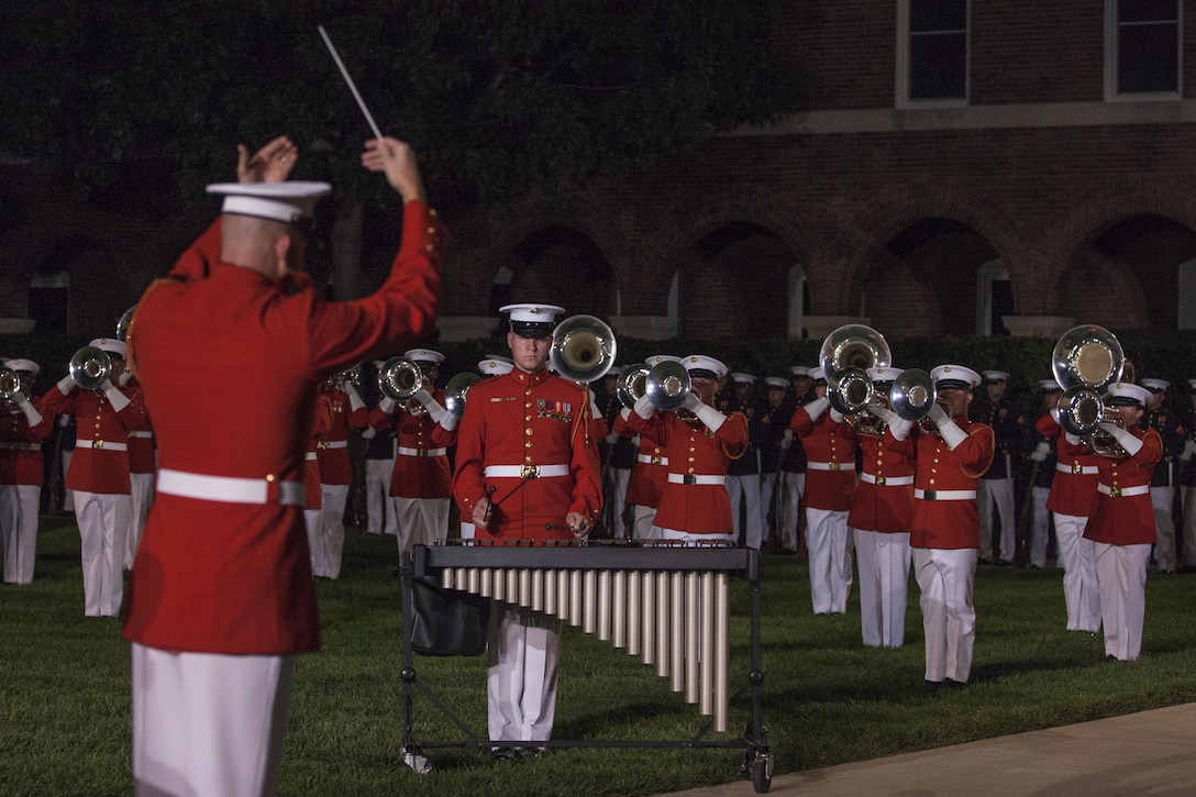 The U.S. Marine Drum and Bugle Corps perform during an evening parade at Marine Barracks Washington, D.C., Aug. 14, 2015. The guest of honor for the evening parade was Lance Cpl. Joshua Leakey, recipient of the Victoria Cross, the highest military decoration for valor in the British and Commonwealth armed forces, and the hosting official was Lt. Gen. Jon Davis, deputy commandant for Aviation. The Evening Parade began in 1934 and features the Silent Drill Platoon, the U.S. Marine Band, the U.S. Marine Corps Drum and Bugle Corps, and two marching companies. More than 3500 guests attend the parade every week. (U.S. Marine Corps photo by Lance Cpl. Samantha K. Draughon/Released)
