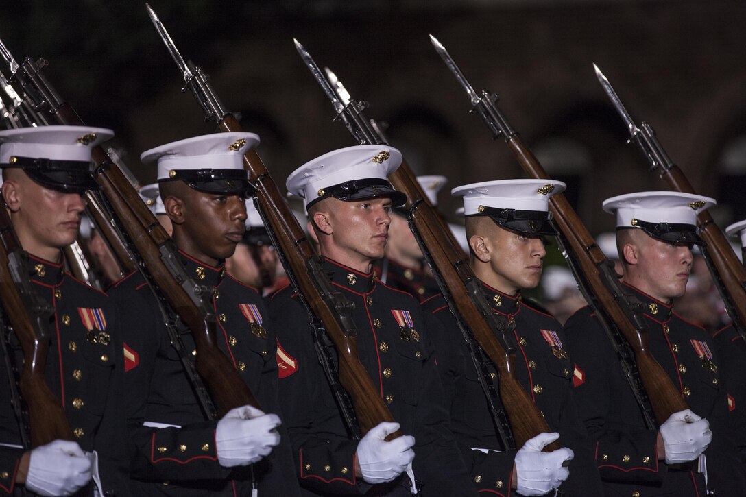 U.S. Marines with Marine Barracks Washington, D.C., pass in review during an evening parade at Marine Barracks Washington, D.C., Aug. 14, 2015. The guest of honor for the evening parade was Lance Cpl. Joshua Leakey, recipient of the Victoria Cross, the highest military decoration for valor in the British and Commonwealth armed forces, and the hosting official was Lt. Gen. Jon Davis, deputy commandant for Aviation. The Evening Parade began in 1934 and features the Silent Drill Platoon, the U.S. Marine Band, the U.S. Marine Corps Drum and Bugle Corps, and two marching companies. More than 3500 guests attend the parade every week. (U.S. Marine Corps photo by Lance Cpl. Samantha K. Draughon/Released)