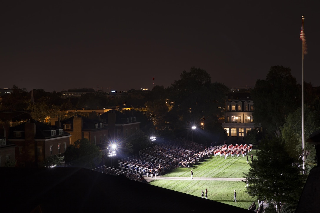 Marines with Marine Barracks Washington, D.C., perform during an evening parade, Aug. 14, 2015. Lance Cpl. Joshua Leakey, recipient of the Victoria Cross, the highest military decoration for valor in the British and Commonwealth armed forces, was the guest of honor and Lt. Gen. Jon M. Davis, deputy commandant for Aviation, was the hosting official for that same parade. The Evening Parade began in 1934 and features the Silent Drill Platoon, the U.S. Marine Band, the U.S. Marine Corps Drum and Bugle Corps, and two marching companies. More than 3500 guests attend the parade every week. (U.S. Marine Corps photo by Lance Cpl. Christopher J. Nunn/Released)