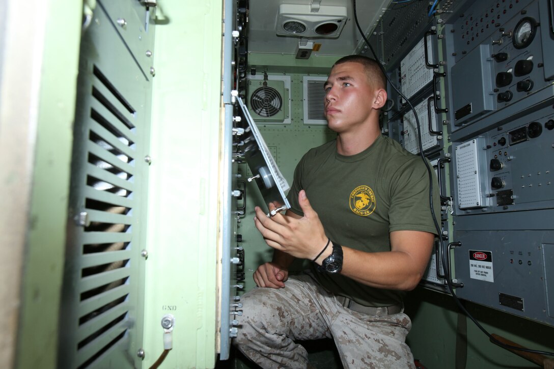 Cpl. Justin J. Pratt inspects equipment inside a vehicle that houses the power for completing the mission during Marine Wing Communications Squadron 28’s field training exercises at Camp Davis and Outlying Landing Field Atlantic, North Carolina, Aug.12, 2015. The training served as a refresher course and is typically held anywhere from two to three times per year for tropospheric scatter radio multi-channel equipment-related military occupational specialties in the squadron. Pratt is a tropospheric scatter radio multi-channel equipment operator with MWCS-28.
