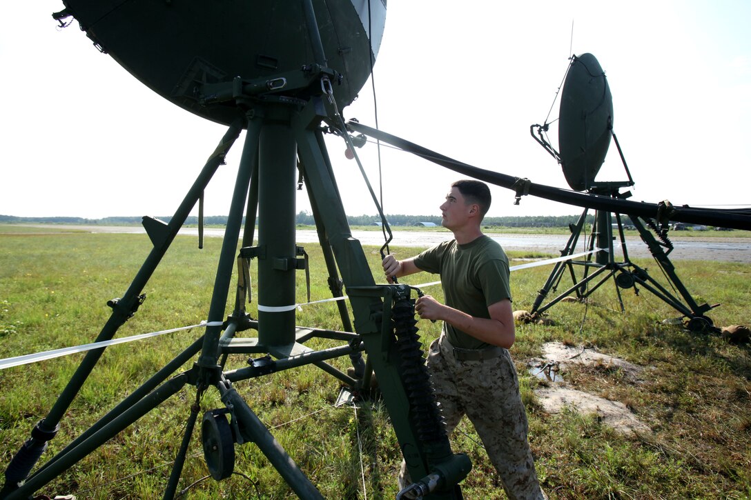 Lance Cpl. Michael Krouse adjusts the antenna to “sweep” for a beam located in the troposphere during Marine Wing Communications Squadron 28’s field training exercises at Camp Davis and Outlying Landing Field Atlantic, North Carolina, Aug.12, 2015. The training served as a refresher course and is typically held anywhere from two to three times per year for tropospheric scatter radio multi-channel equipment-related military occupational specialties in the squadron. Krouse is a tropospheric scatter radio multi-channel equipment operator with MWCS-28.
