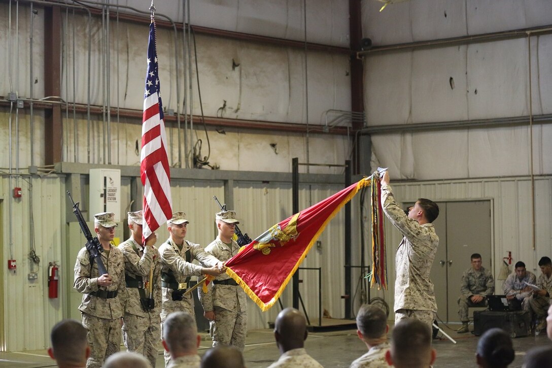 One by one, Marines with Special Purpose Marine Air Ground Task Force-Crisis Response-Central Command place a battle streamer on the Regimental Colors to symbolize the 7th Marine Regiment’s unit awards during the 98th anniversary ceremony, held in an undisclosed location in Southwest Asia, Aug. 15, 2015. The 7th Marine Regiment Headquarters and 3rd Battalion, 7th Marines are currently deployed with the SPMAGTF-CR-CC and took time to remember the regiment’s storied history and rededicate themselves to their current work with Operation Inherent Resolve.