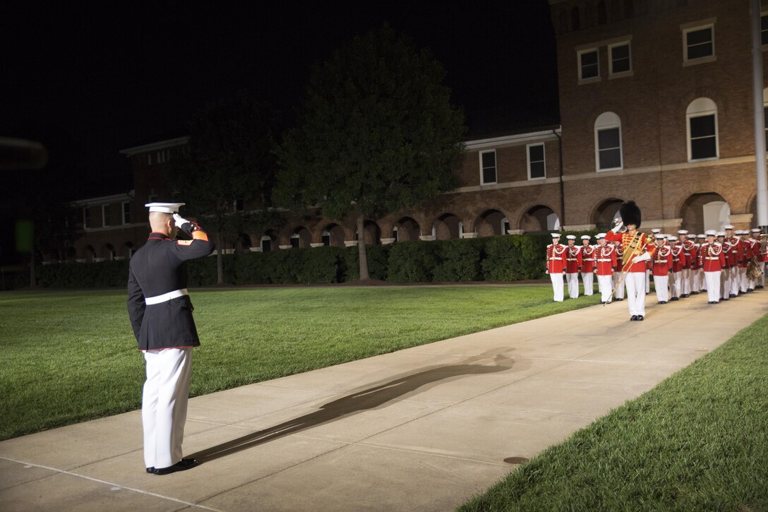 1st Sgt. Michael Brown salutes the United States Marine Band during the Friday Evening Parade at Marine Barracks Washington, D.C., Aug. 14, 2015.  The guest of honor for the Evening Parade was Lance Cpl. Joshua Leakey, recipient of the Victoria Cross, the highest decoration for valor in the British and Commonwealth armed forces, and the hosting official was Lt. Gen. Jon Davis, deputy commandant for Aviation. (Official Marine Corps photo by Cpl. Chi Nguyen/Released)