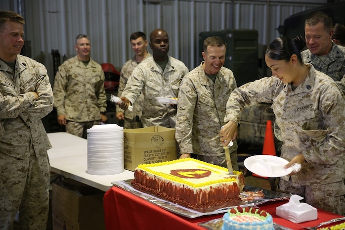 Col. Jay M. Bargeron and Marines with Special Purpose Marine Air Ground Task Force-Crisis Response-Central Command celebrate the 7th Marine Regiment’s 98th anniversary after a ceremony, held in an undisclosed location in Southwest Asia, Aug. 15, 2015. The 7th Marine Regiment Headquarters and 3rd Battalion, 7th Marines are currently deployed with the SPMAGTF-CR-CC and took time to remember the regiment’s storied history and rededicate themselves to their current work with Operation Inherent Resolve.