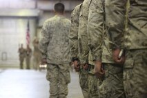 Marines with Special Purpose Marine Air Ground Task Force-Crisis Response-Central Command stand across from the color guard awaiting the order to hang the battle streamers on 7th Marine Regiment’s Colors during the regiment’s 98th anniversary ceremony, held in an undisclosed location in South West Asia, Aug. 15, 2015. The 7th Marine Regiment Headquarters and 3rd Battalion, 7th Marines are currently deployed with the SPMAGTF-CR-CC and took time to remember the regiment’s storied history and rededicate themselves to their current work with Operation Inherent Resolve.