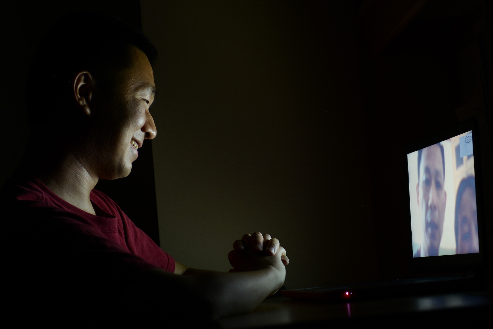 Airman 1st Class Bin Ma, a 20th Comptroller Squadron financial services technician, speaks with his parents through a video chat in his dorm room at Shaw Air Force Base, S.C., Aug. 2, 2015. Ma is hoping to soon visit his parents in China who he hasn’t seen in seven years and is anticipating bringing them to America as U.S. citizens in a few years. (U.S. Air Force photo/Senior Airman Diana M. Cossaboom)