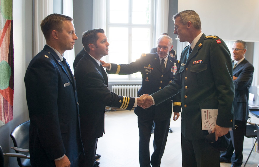 U.S. Army Gen. Martin E. Dempsey, center, chairman of the Joint Chiefs of Staff, introduces Danish Chief of Defense Army Gen. Peter Bartram to a member of his staff before a security meeting in Copenhagen, Denmark, Aug. 17, 2015. DoD photo by D. Myles Cullen
