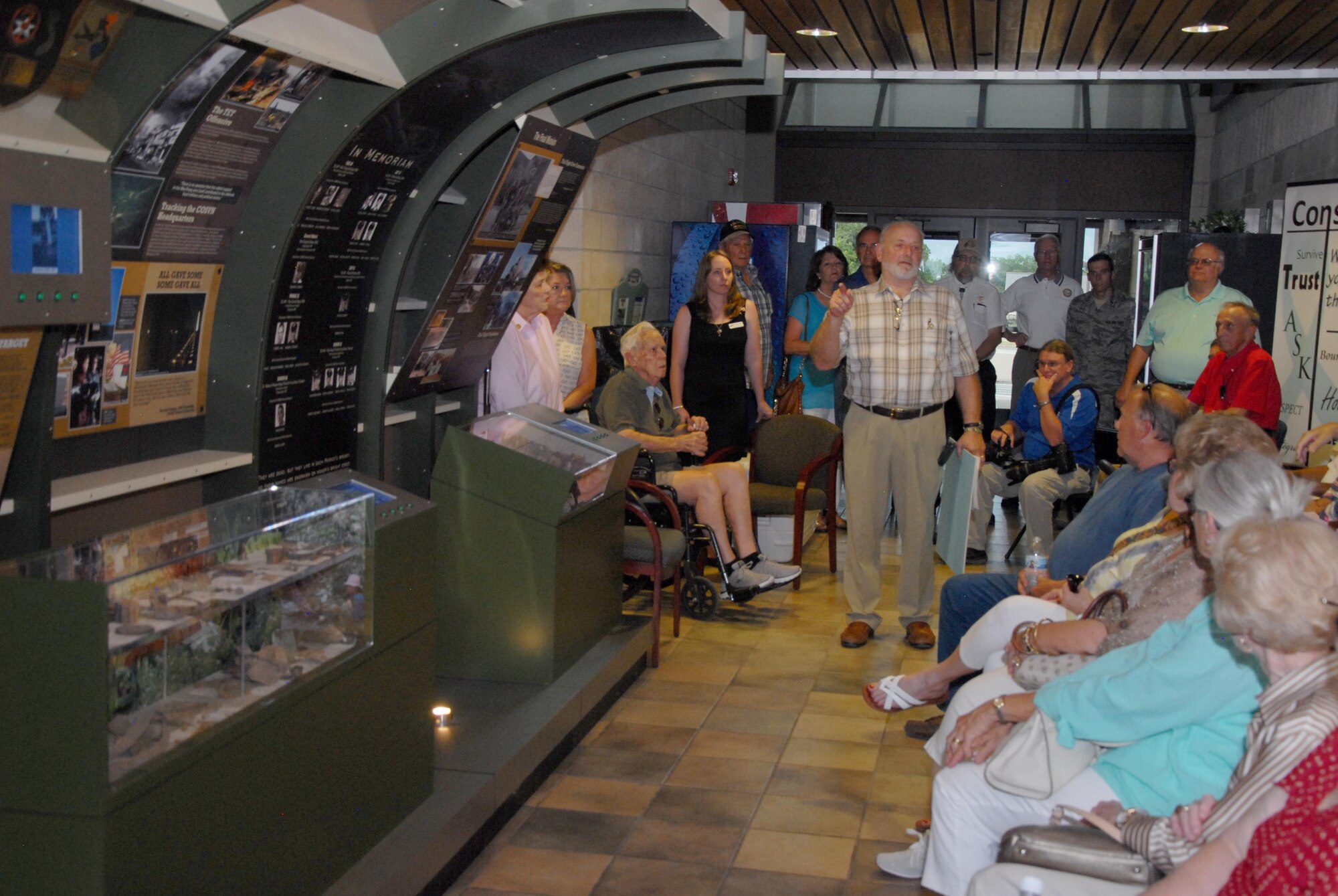 Retired U.S. Air Force Chief Master Sgt. Tom Nurre, Vietnam War veteran, talks about the Airborne Radio Direction Finding display to Vietnam veterans during 50-year commemoration in the Norma Brown Building on Goodfellow Air Force Base, Texas, Aug. 14, 2015. Nurre told the audience the artifacts in the display were donated by Paul and Nita Clever, a couple who found the crash site where Paul’s father and nine other service members crashed during the Vietnam War. (U.S. Air Force photo by Senior Airman Joshua Edwards/Released)