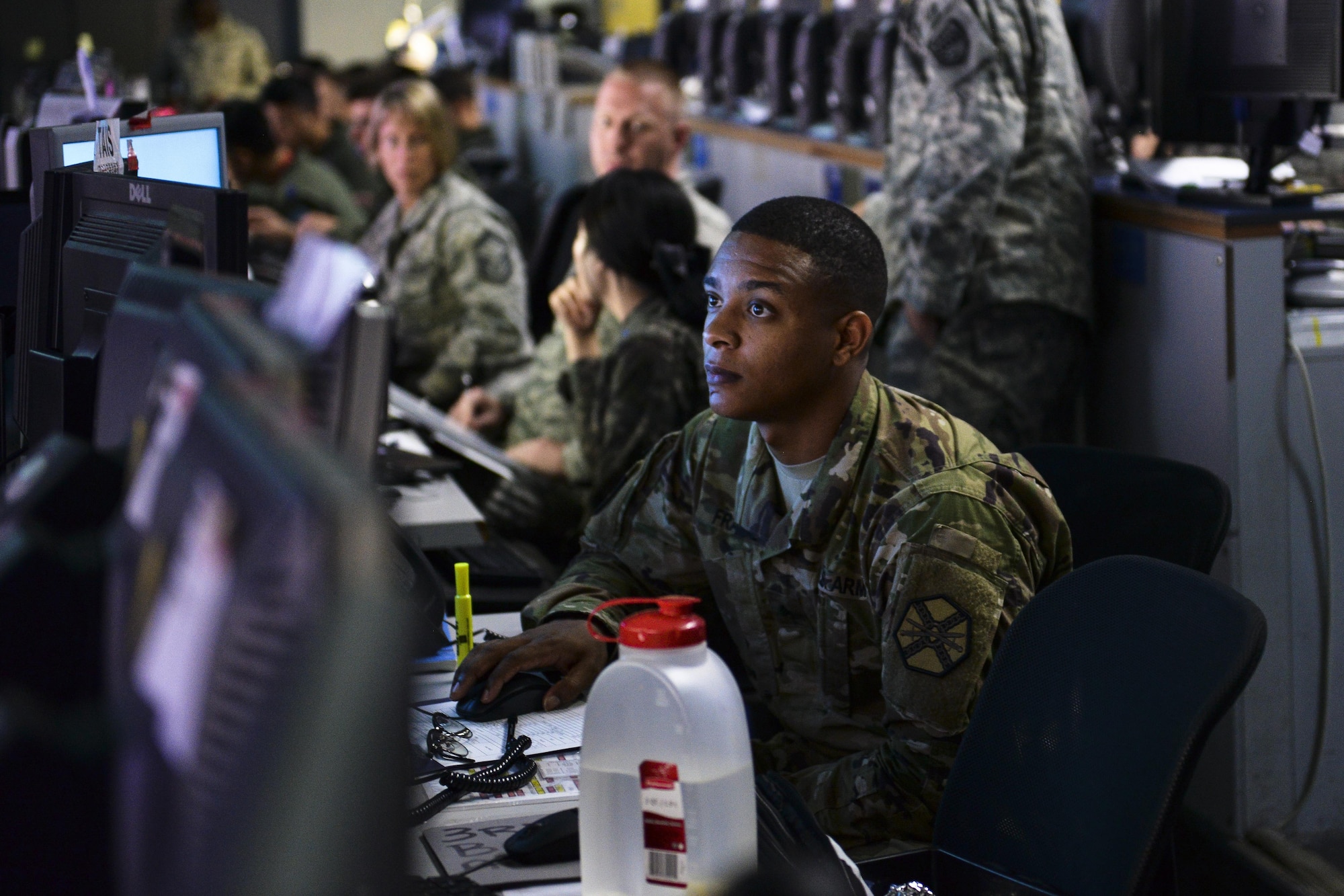 U.S. Army Sgt. Dennis Franklin, Headquarters and Headquarters Company Management Command Yongsan air traffic controller, monitors air space throughout the Indo-Asian-Pacific region at the Hardened Theater Air Control Center, Osan Air Base, Republic of Korea, during the first day of Ulchi Freedom Guardian, Aug. 17, 2015. Approximately 33,000 Airmen, Soldiers, Sailors and Marines from Osan, the Pacific theater and the United States along with other allied militaries are participating in the annual exercise in an effort to enhance the combat readiness of the ROK and U.S. forces. Months of planning went into UFG, preparing joint teams on the operations floor to work together and maximize their collaborated efforts. Portions of the image were blurred for security concerns. (U.S. Air Force illustration by Airman 1st Class John Linzmeier/Released)