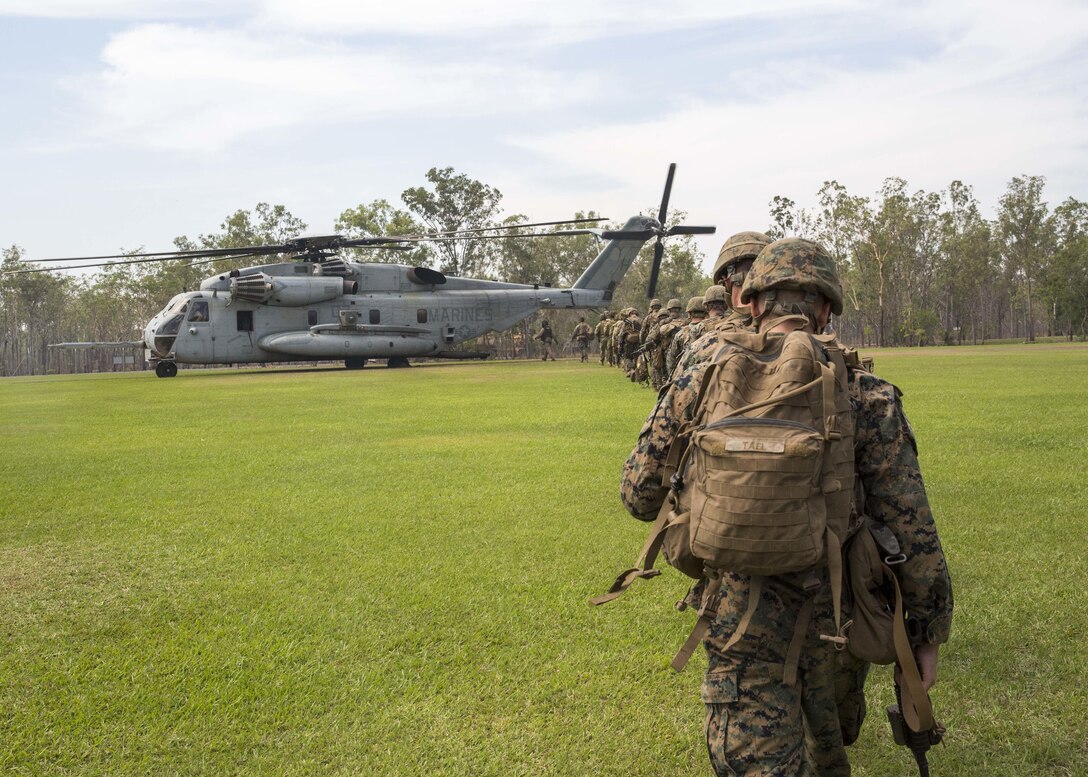 U.S. Marines with Company C, 1st Battalion, 4th Marine Regiment, Marine Rotational Force – Darwin, and Australian soldiers with Delta Company, 5th Battalion, The Royal Australian Regiment, Australian Army, Australian Defence Force, board a CH-53E Super Stallion helicopter with Marine Heavy Helicopter Squadron 463, MRF-D, Aug. 7 at Robertson Barracks, Palmerston, Northern Territory, Australia. The Marines are a part of the Marine Air-Ground Task Force that is composed of aviation, ground and logistics combat elements that create MRF-D. The rotational deployment in Darwin enables Marines to more effectively train, exercise and operate with their partners, enhancing regional security and building a capacity to respond more rapidly to natural disasters and crises throughout that region. 