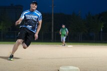 Senior Airman Alexander Oelfke, 8th Security Forces Squadron member, runs passed third base during the intramural softball championship game at Kunsan Air Base, Republic of Korea, Aug. 17, 2015. The game’s final score ended with the MXS dragons defeating the 8th Security Forces Squadron 16 to 5. (U.S. Air Force photo by Senior Airman Divine Cox/Released)