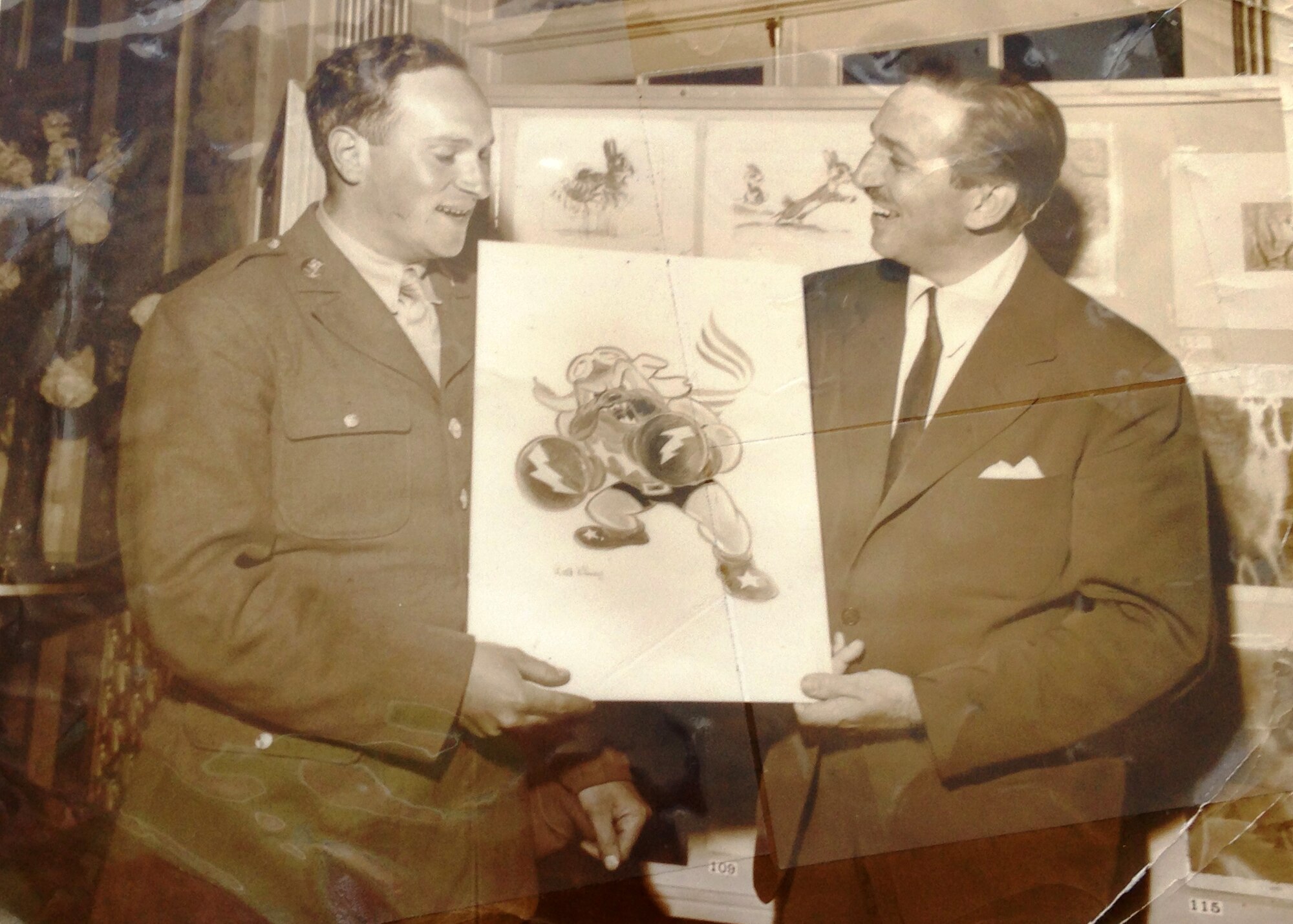While stationed at Luke, Sgt. Seymour Pine had the unique privilege of accepting the 62nd Fighter Squadron emblem of a boxing bulldog from the artist who drew it—Walt Disney. (Courtesy photo from Richard Pine)