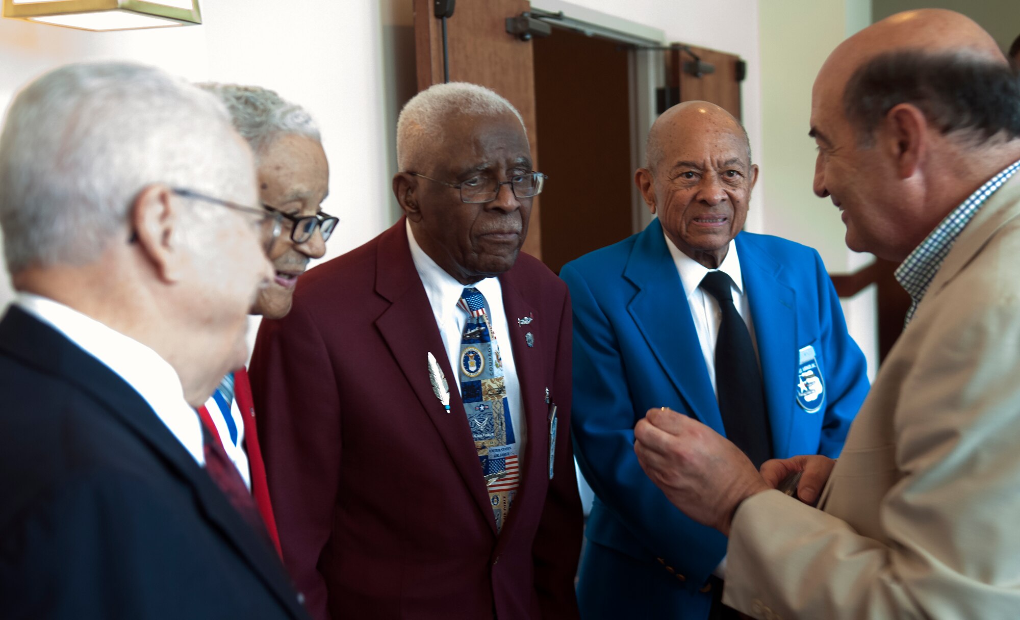 From left to right, retired Lt. Col. George Hardy, Col. Charles McGee, and Lt. Cols. James Harvey and Harry Stewart, four of the original Tuskegee pilots, speak with Wyoming State Senator Stephan Pappas during a reception at the Historic Plains Hotel, Cheyenne, Wyo., August 14, 2015. As a retired brigadier general, Pappas was able to speak about many changes he saw in the Air Force that came about from the achievements of the Tuskegee Airmen. (U.S. Air Force photo by Airman 1st Class Brandon Valle)