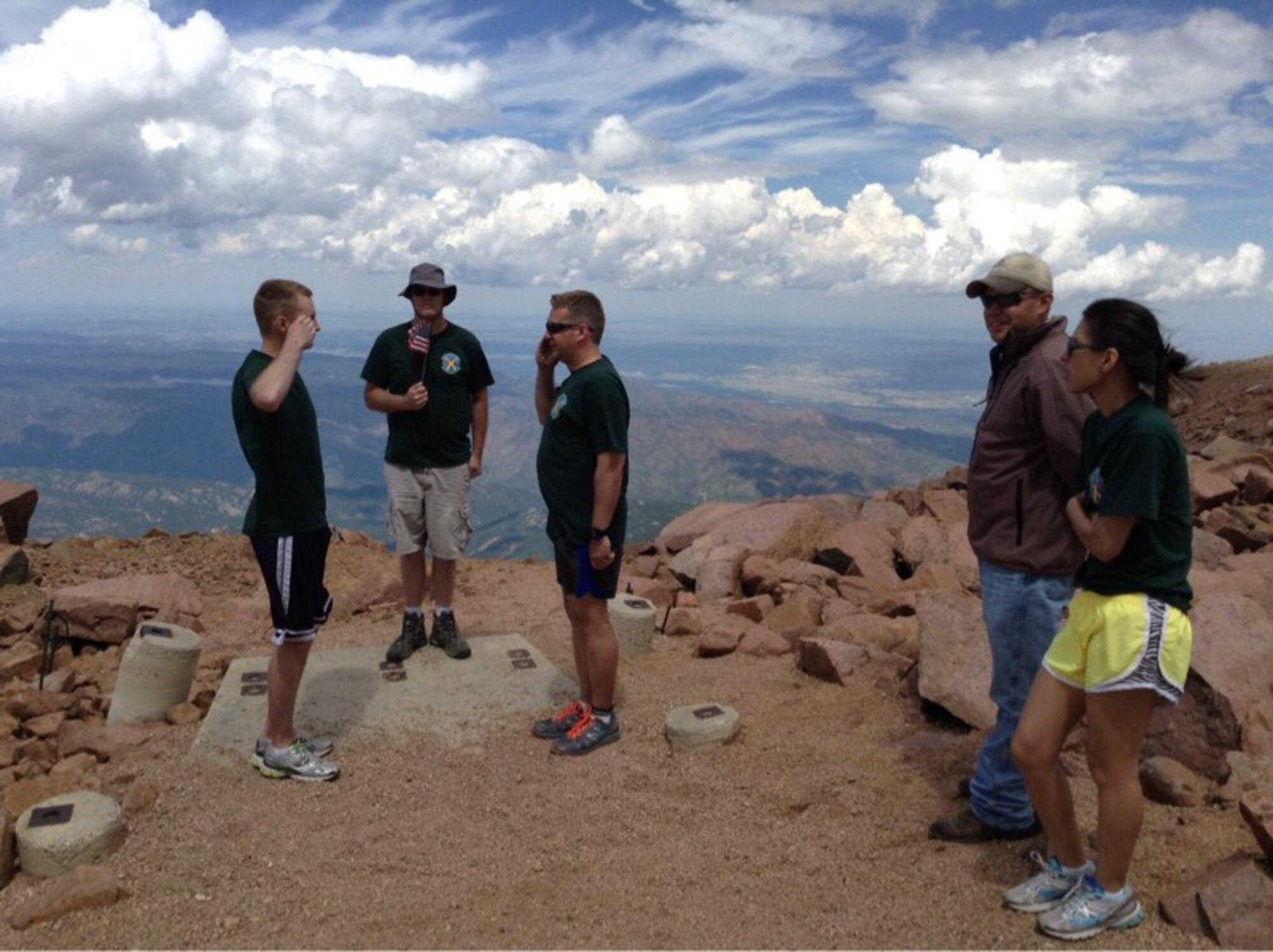 New Air Force Reserve Staff Sgt. Joe George is promoted by Lt. Col. Sam Baxter, 19th Space Operations Squadron commander, on top of Pikes Peak, Aug. 1, 2015.  Also on hand for the promotion were Maj. Michael Rose (with the flag), Master Sgt. Jeremy Correll and George’s wife Chi. (Courtesy photo)