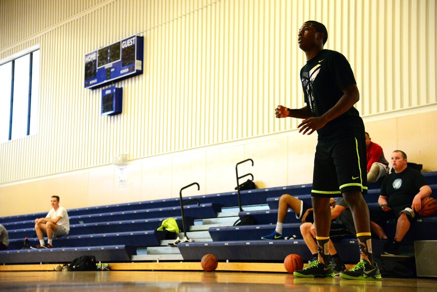 Airman Derrick Norman, 341st Force Support Squadron, plays offense during a basketball game amongst peers at the Malmstrom Fitness and Sports Center Aug. 12, 2015, at Malmstrom Air Force Base, Mont. Norman brings a positive dynamic to the 341st FSS team by being the assistant special events coordinator and an avid lover of basketball.  (U.S. Air Force photo/Airman 1st Class Magen M. Reeves)