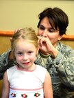 Col. Denise L. Cooper, 341st Mission Support Group commander, ties a ponytail in daughter Jenna’s hair Aug. 14, 2015, at Malmstrom Air Force Base, Mont. Cooper balances being a mother, wife and a new group commander 24 hours a day, seven days a week, 365 days a year. (U.S. Air Force photo/Airman 1st Class Magen M. Reeves)