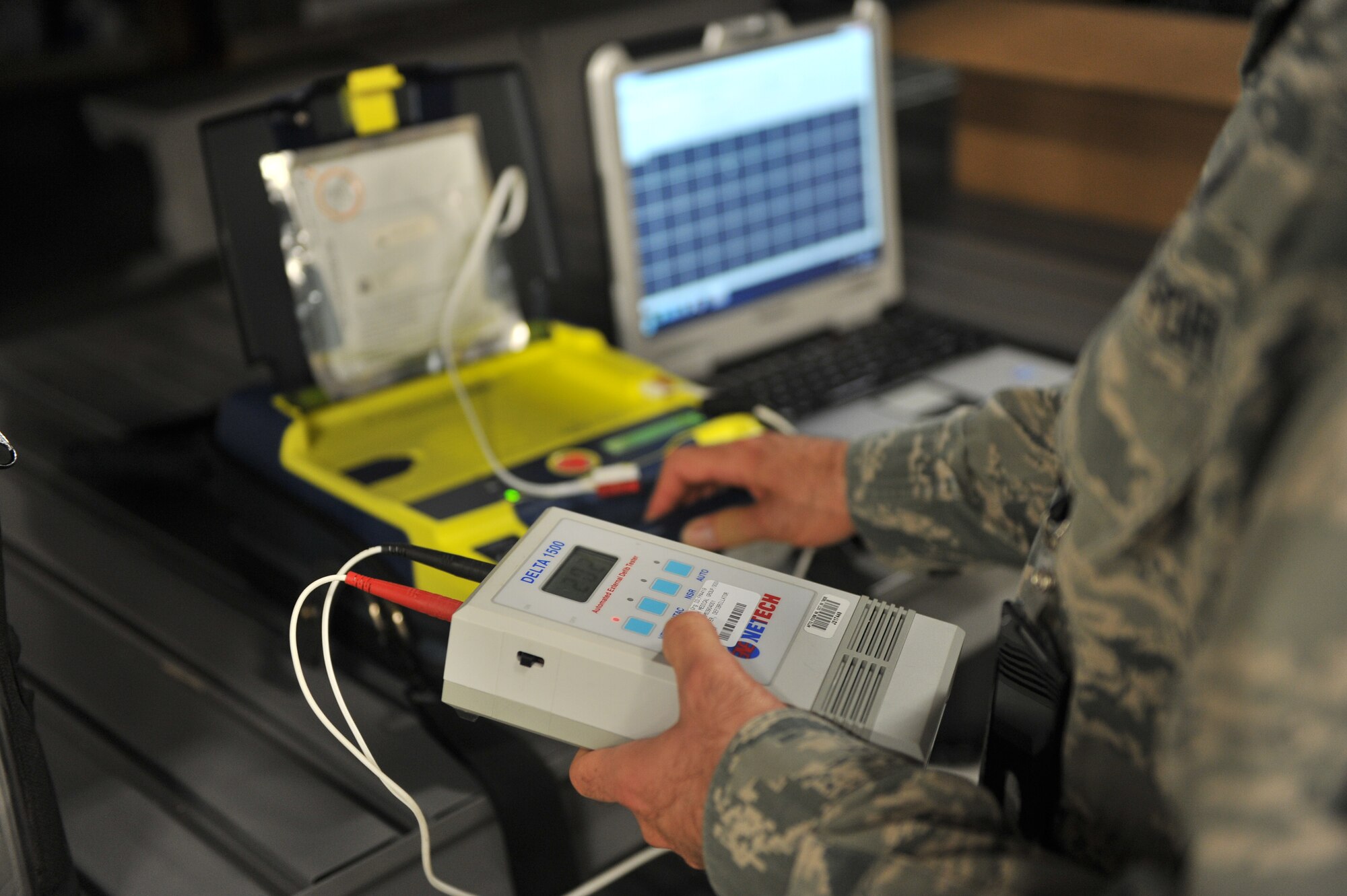 ALTUS AIR FORCE BASE, Okla. – U.S. Air Force Tech. Sgt. Christian Bond, 97th Medical Group bioenvironmental medical equipment technician, tests an automated external defibrillator as part of routine maintenance on the devices inside medical group warehouse, Aug. 13, 2015. Every AED device on base is supplied and maintained by the logistics flight to ensure safety for personnel. (U.S. Air Force photo by Senior Airman Dillon Davis/Released)