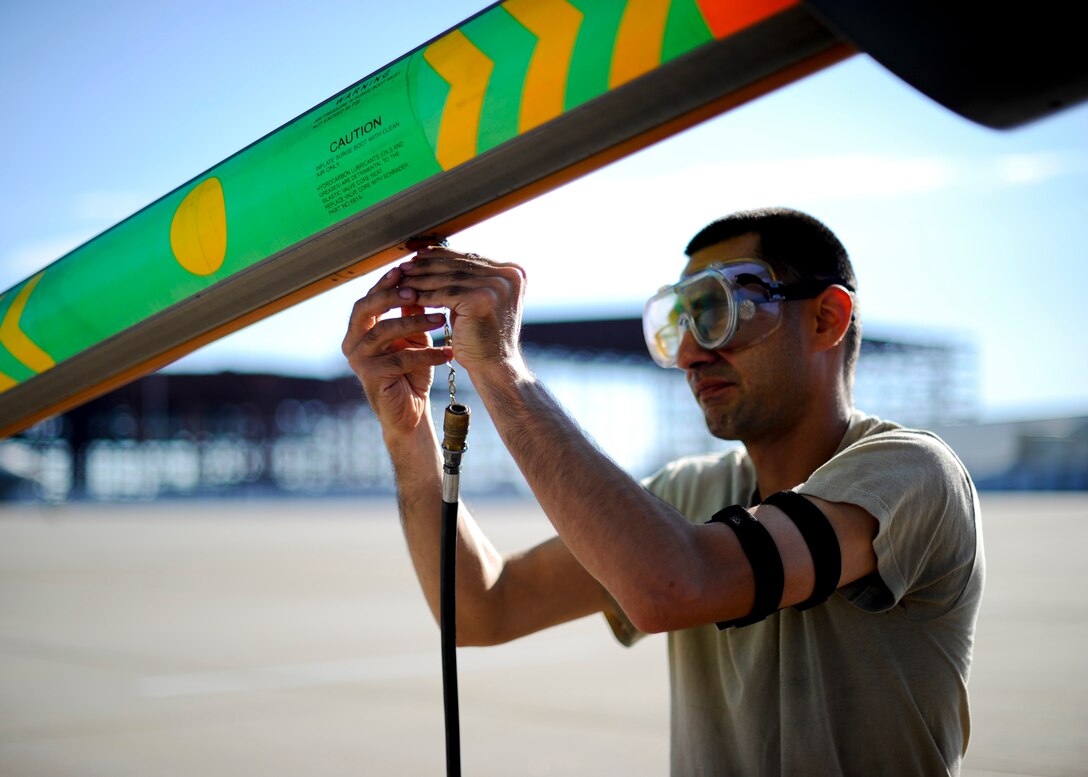 Staff Sgt. Shawn Mason, 22nd Aircraft Maintenance Squadron hydraulics shop craftsman, services the surge boots on the boom of a KC-135 Stratotanker, Aug. 13, 2015, at McConnell Air Force Base, Kan. Properly maintained surge boots allows the boom to extend and retract smoothly when not transferring fuel. (U.S. Air Force photo by Senior Airman Victor J. Caputo)