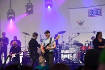 Gary Sinise, actor and Lt. Dan Band co-founder, plays a concert outside of Malmstrom Air Force Base’s Fitness and Sports Center Aug 16. Since its inception in 2003, the band has played hundreds of shows for military members all across the globe. (U.S. Air Force photo/Airman 1st Class Collin Schmidt)