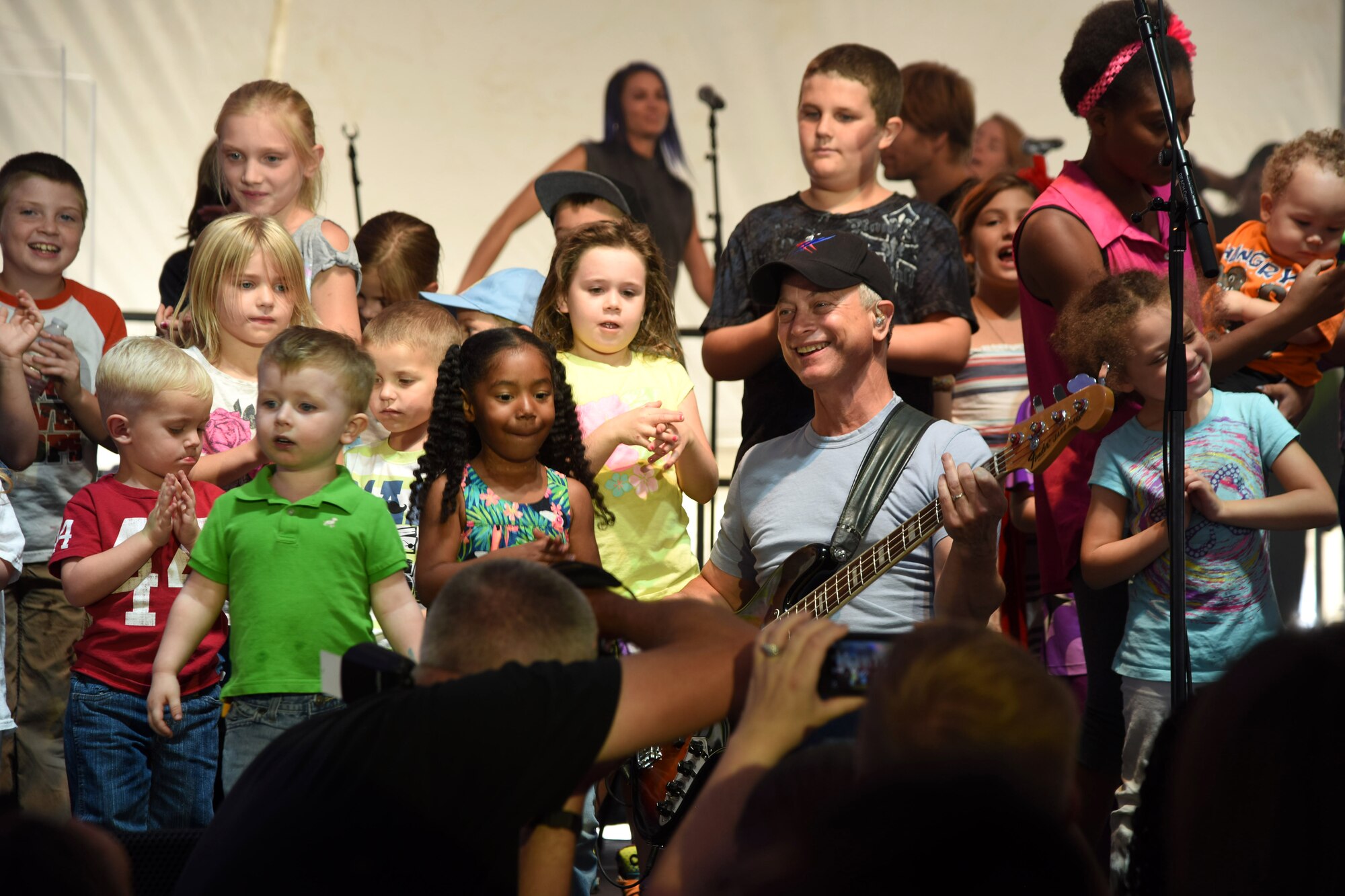 Gary Sinise, actor and Lt. Dan Band co-founder, plays a concert outside of Malmstrom Air Force Base’s Fitness and Sports Center Aug. 16. The band performed 24 songs for the more than 1,500 attendees. Some of the children even had the opportunity to join Sinise on stage. (U.S. Air Force photo/Airman 1st Class Collin Schmidt)
