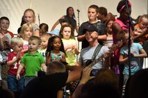 Gary Sinise, actor and Lt. Dan Band co-founder, plays a concert outside of Malmstrom Air Force Base’s Fitness and Sports Center Aug. 16. The band performed 24 songs for the more than 1,500 attendees. Some of the children even had the opportunity to join Sinise on stage. (U.S. Air Force photo/Airman 1st Class Collin Schmidt)