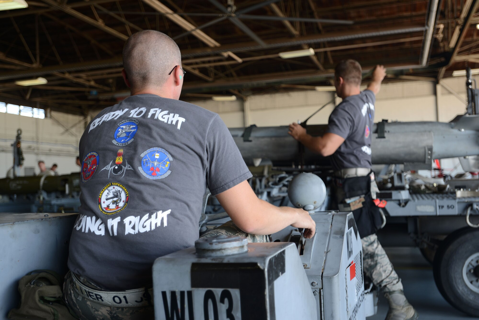 U.S. Air Force Airmen from the 20th Equipment Maintenance Squadron load munitions onto a weapons loader, called a jammer, during a weapons load crew of the quarter competition at Shaw Air Force Base, S.C., Aug. 14, 2015. Jammers are used to transport heavy munitions to an aircraft in order to be loaded. (U.S. Air Force photo by Airman 1st Class Kelsey Tucker/Released)